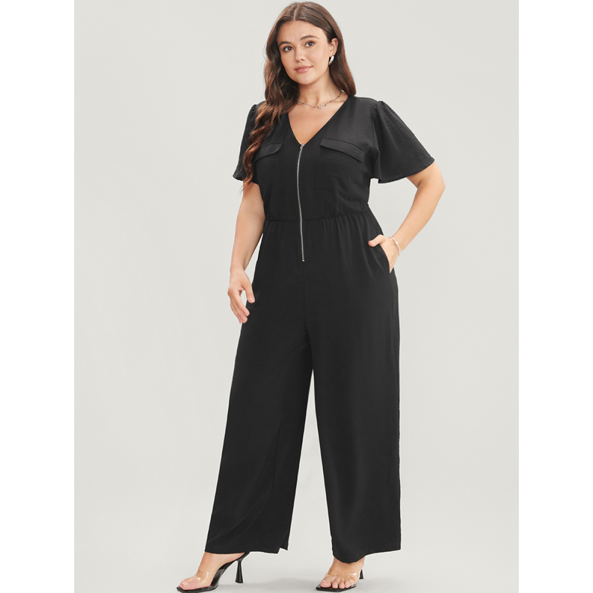 Plus Size Black Solid Zip Up Pocket Ruffle Sleeve Jumpsuit Women Office Short sleeve V-neck Work Loose Jumpsuits BloomChic
Plus Size Black Solid Zip Up Pocket Ruffle Sleeve Jumpsuit Women Office Short sleeve V-neck Work Loose Jumpsuits BloomChic