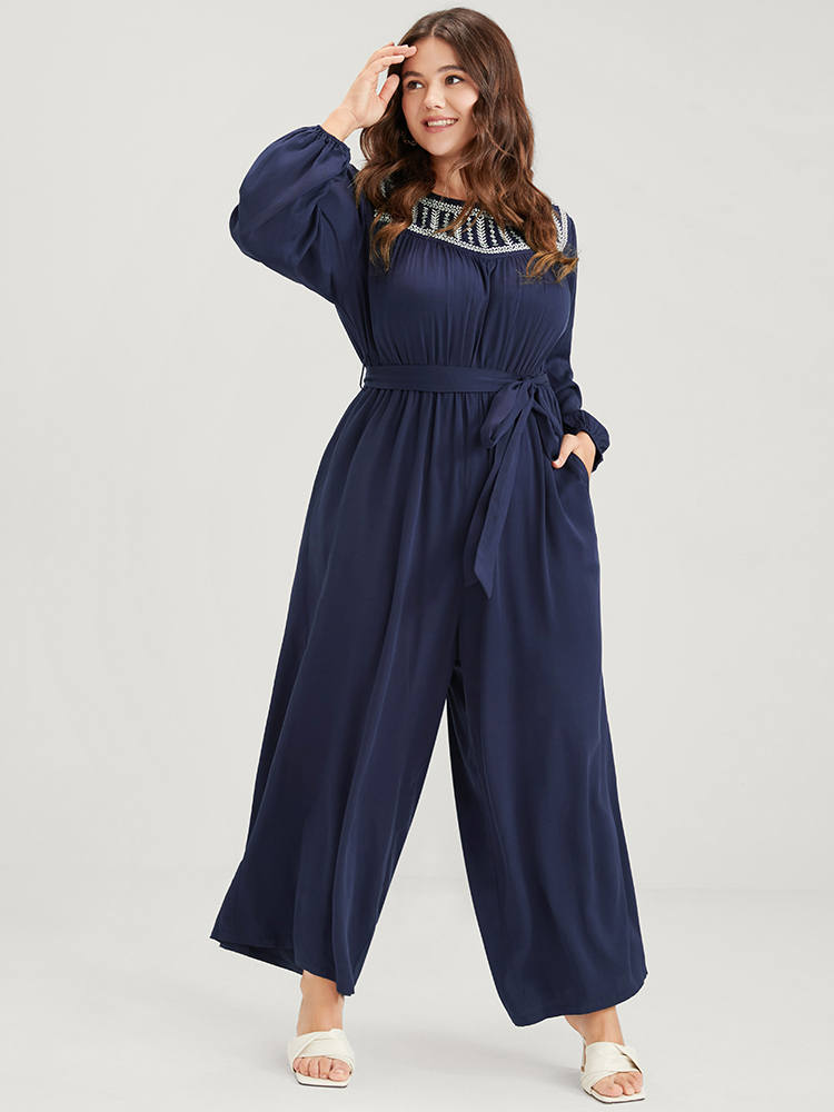 

Plus Size DarkBlue Solid Pocket Lantern Sleeve Embroidered Belted Jumpsuit Women Elegant Long Sleeve Round Neck Dailywear Loose Jumpsuits BloomChic