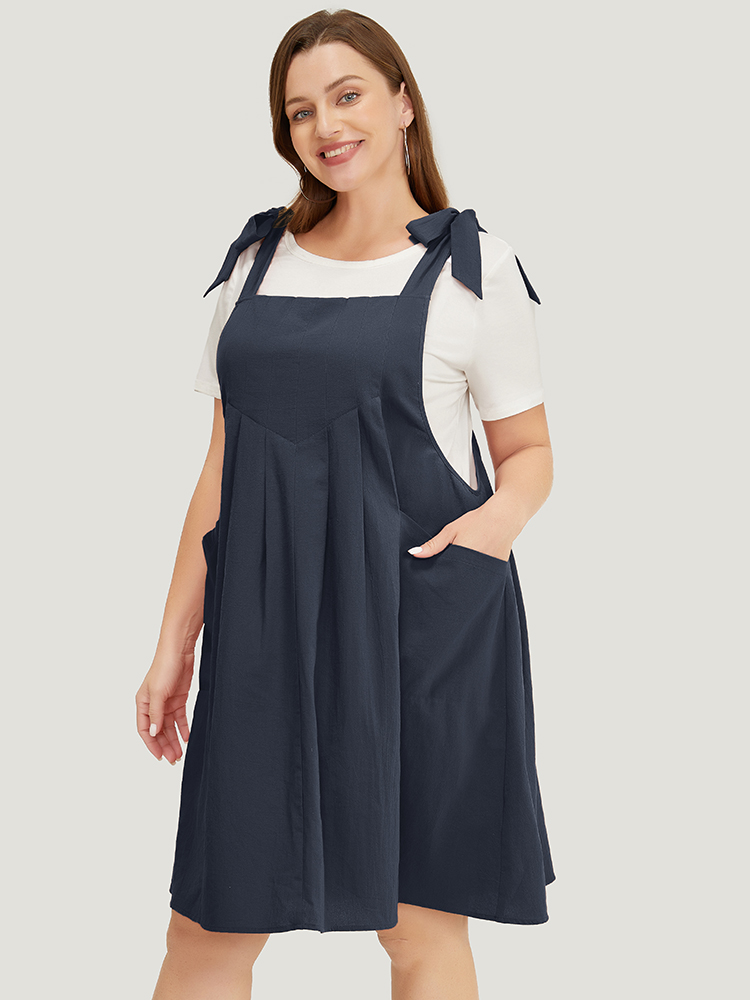 

Plus Size Solid Pleated Hem Pocket Tie Shoulder Overall Dress Navy Women Casual Pleated Spaghetti Strap Sleeveless Curvy Knee Dress BloomChic