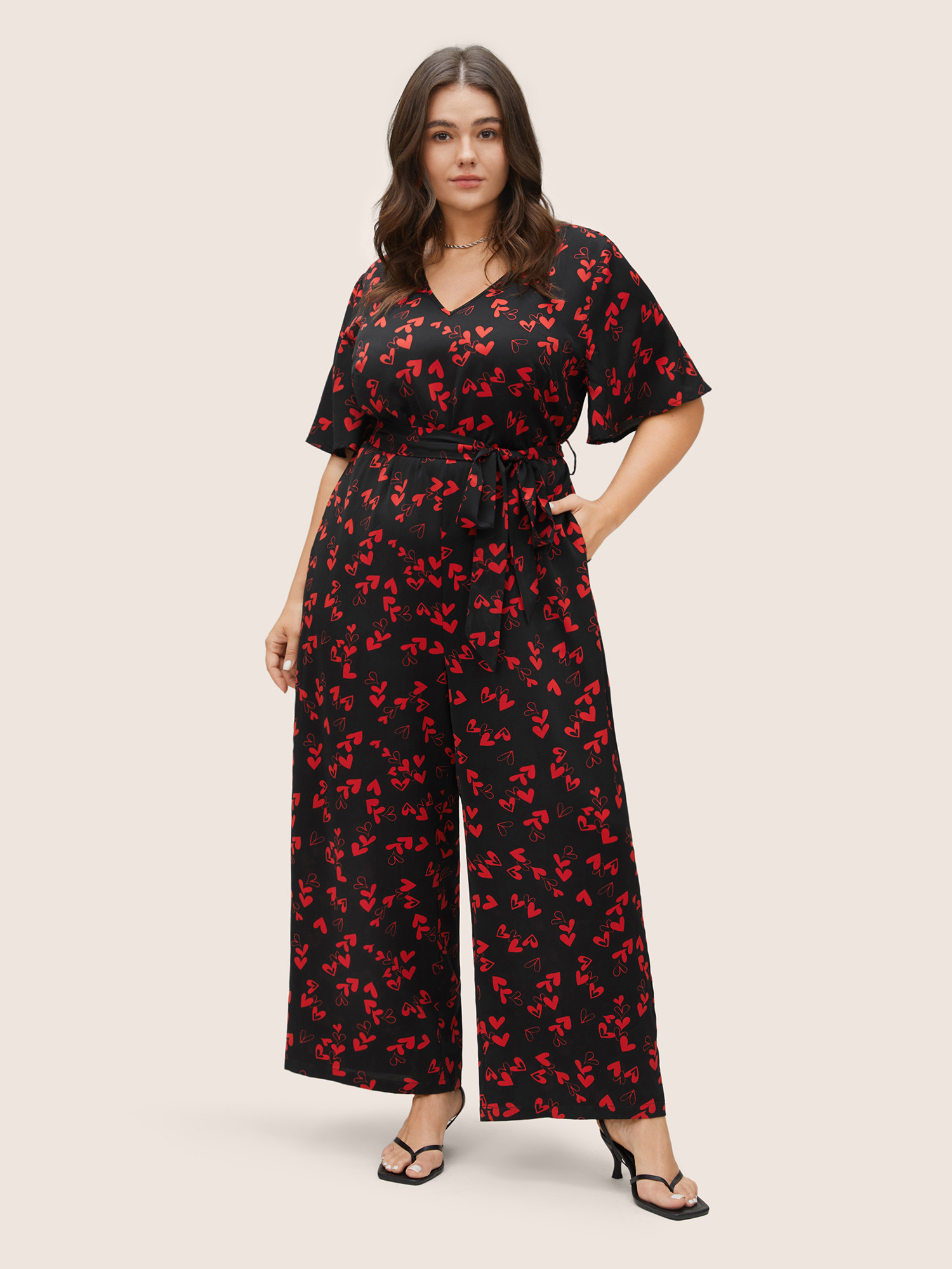 

Plus Size Black Heart Print Pocket Belted Jumpsuit Women Elegant Short sleeve V-neck Everyday Loose Jumpsuits BloomChic