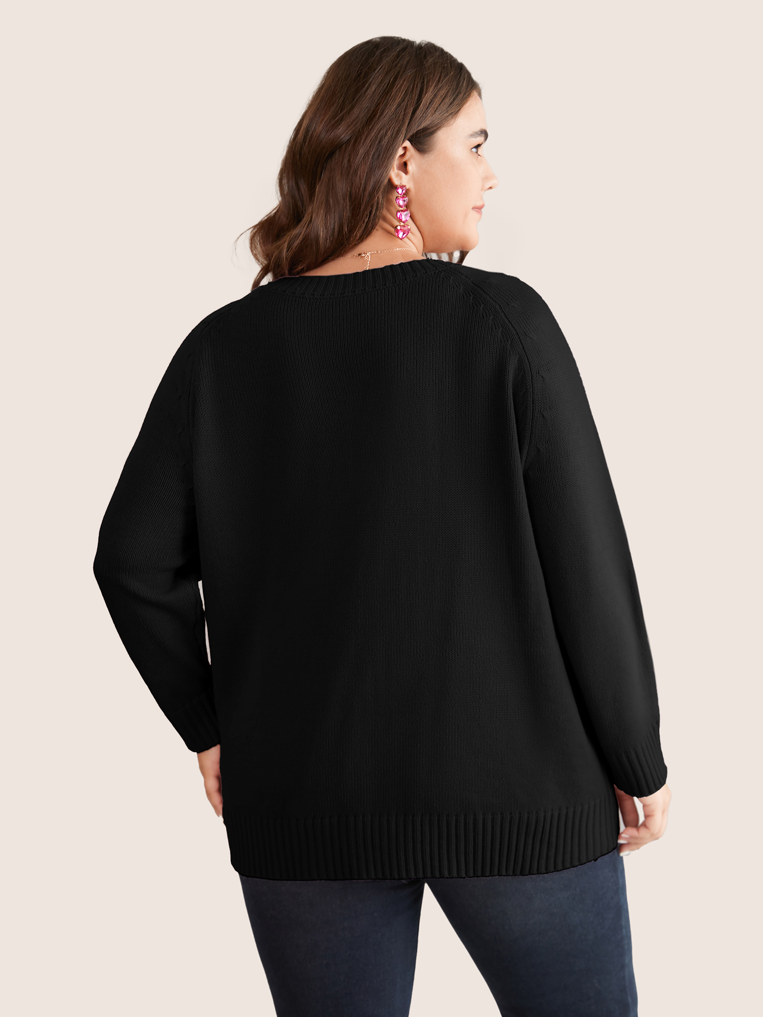 Side view of BloomChic Women's Plus Size Heart Cable Knit Two Tone Raglan Sleeve Pullover Black 26/4X