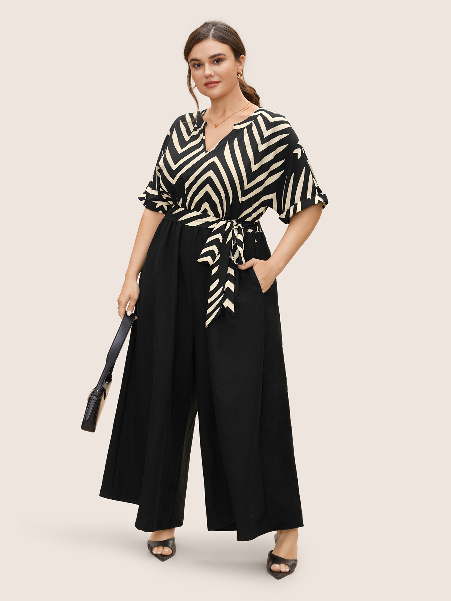 

Plus Size Black Striped Patchwork Knot Cuffed Sleeve Jumpsuit Women Work From Home Half Sleeve Flat collar with V-notch Work Loose Jumpsuits BloomChic
