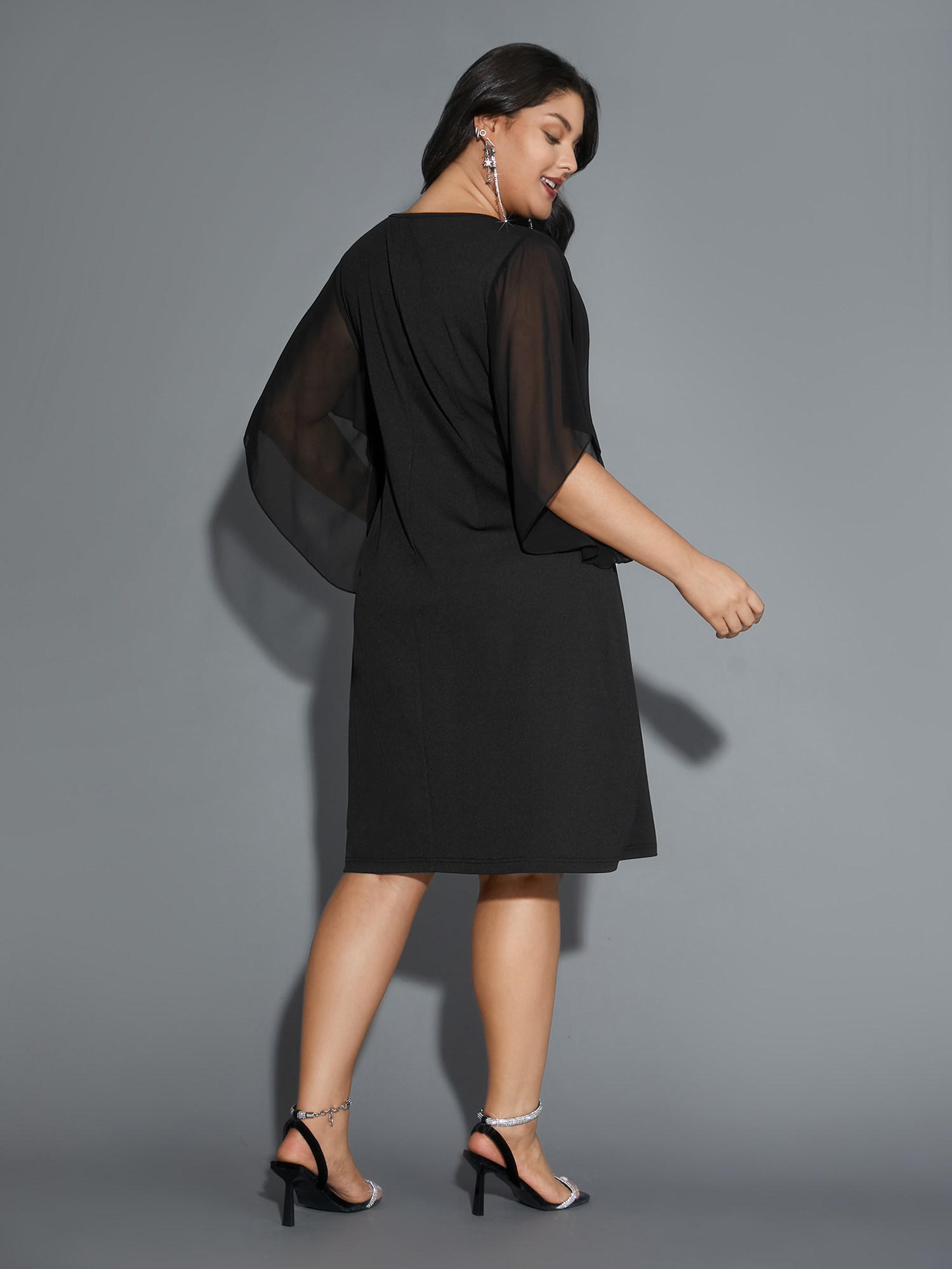 Side view of BloomChic Women's Plus Size Rhinestone Ruffle Sleeve Mesh Patchwork Dress Pureblack Party Mini Rhinestone detailing Round Neck 28/5X