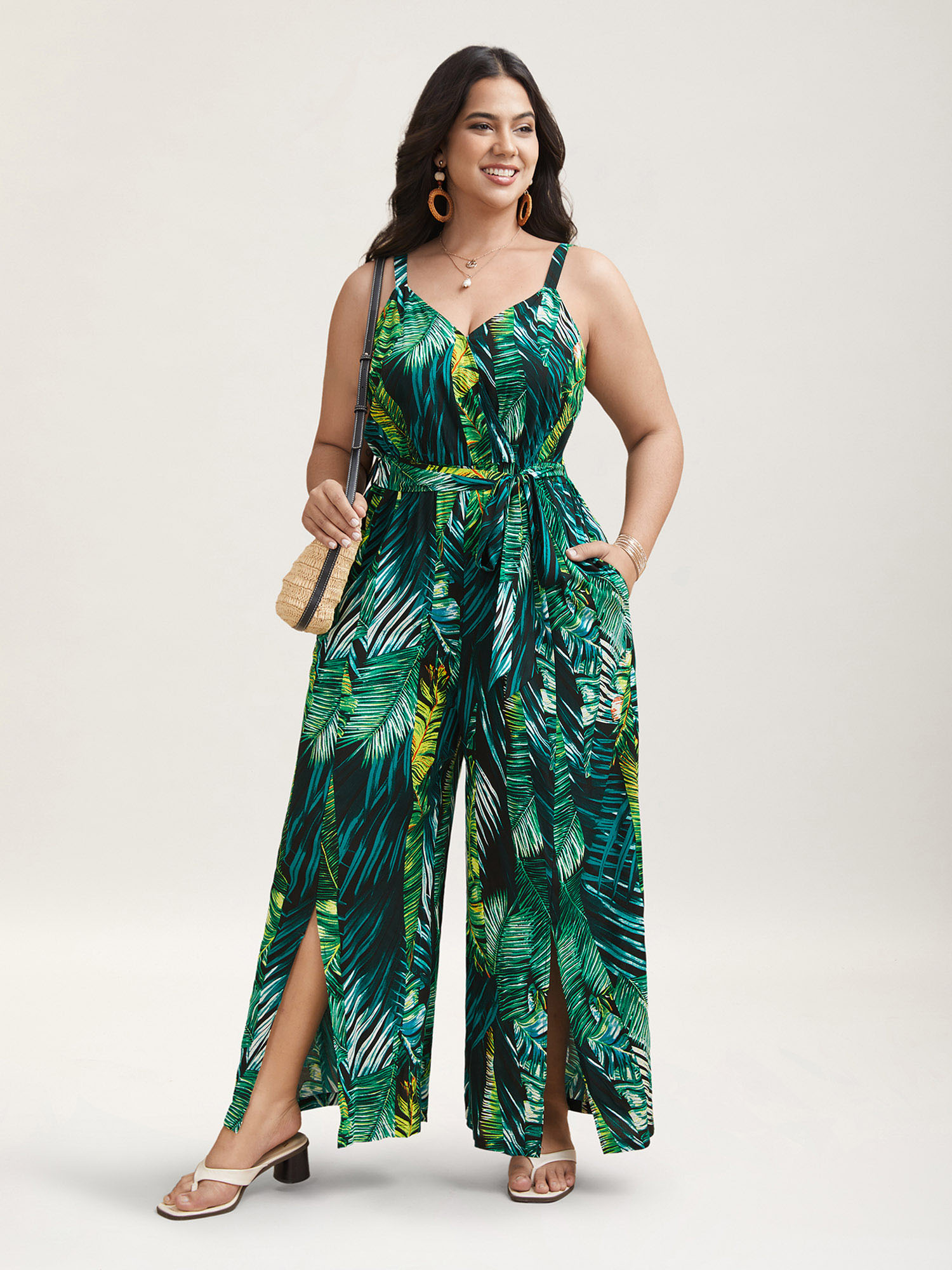 

Plus Size BlackFlower Tropical Leaf Print Stretchy Belted Slit Jumpsuit Women Resort Sleeveless Overlap Collar Vacation Loose Jumpsuits BloomChic