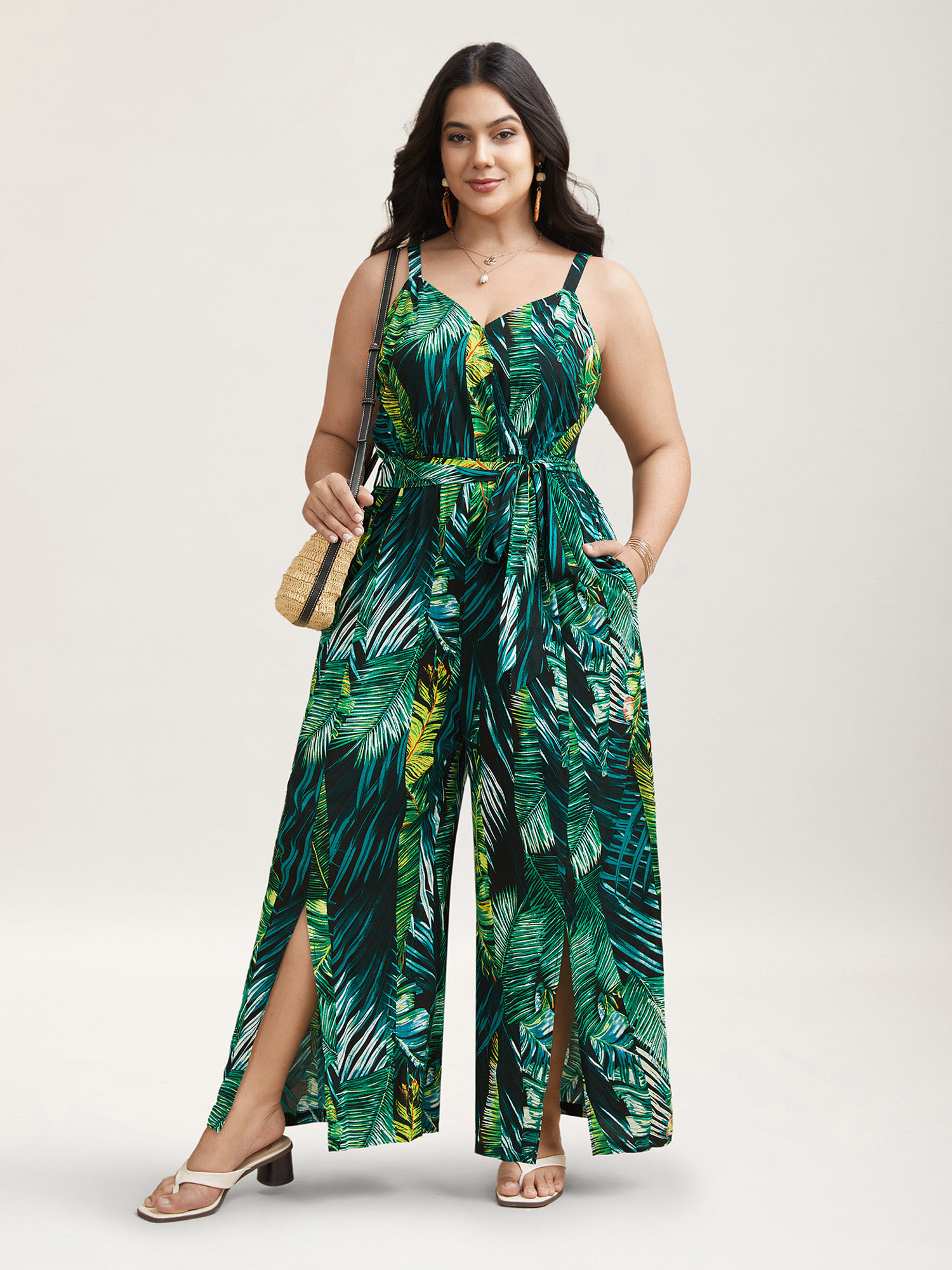 

Plus Size BlackFlower Tropical Leaf Print Stretchy Belted Slit Jumpsuit Women Resort Sleeveless Overlap Collar Vacation Loose Jumpsuits BloomChic