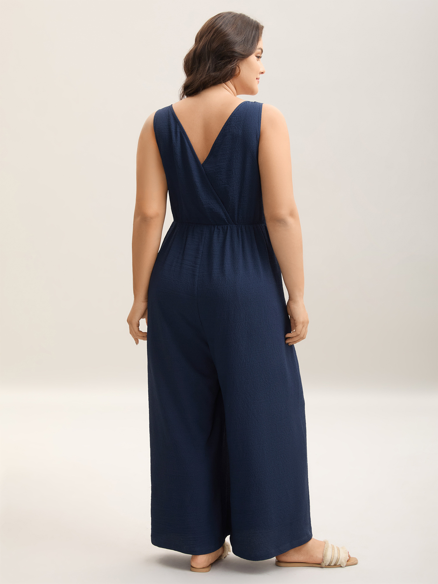 Side view of BloomChic Women's Plus Size Shirred Pockets Wide-Leg Plain Jumpsuit Midnight Vacation 30/6X