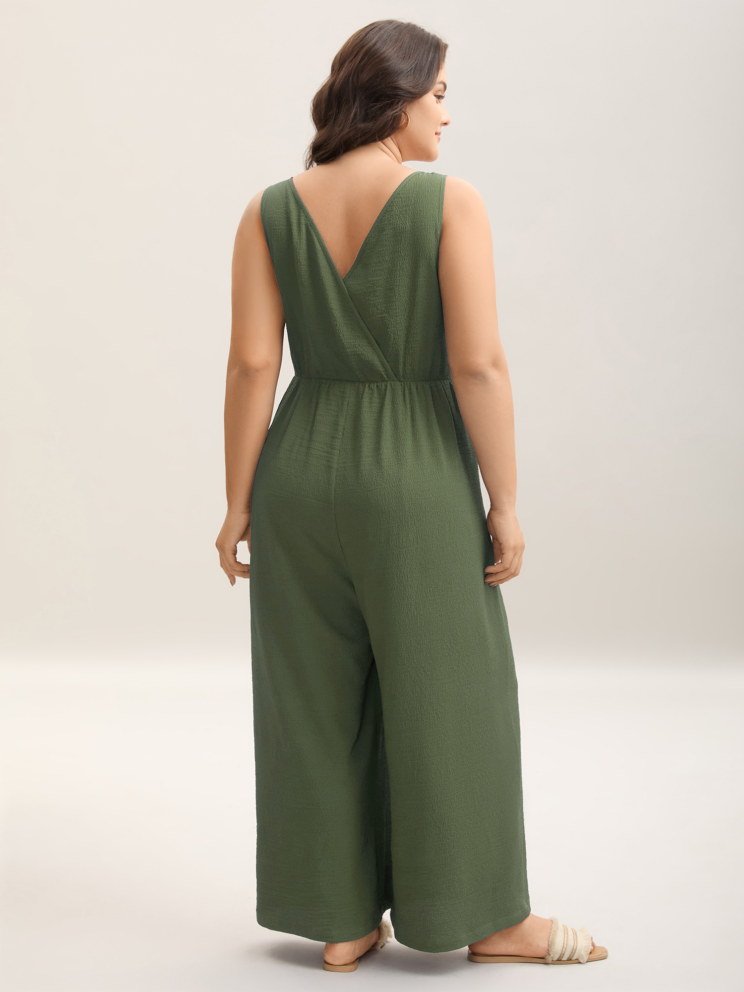 Side view of BloomChic Women's Plus Size Shirred Pockets Wide-Leg Plain Jumpsuit ArmyGreen Vacation 26/4X