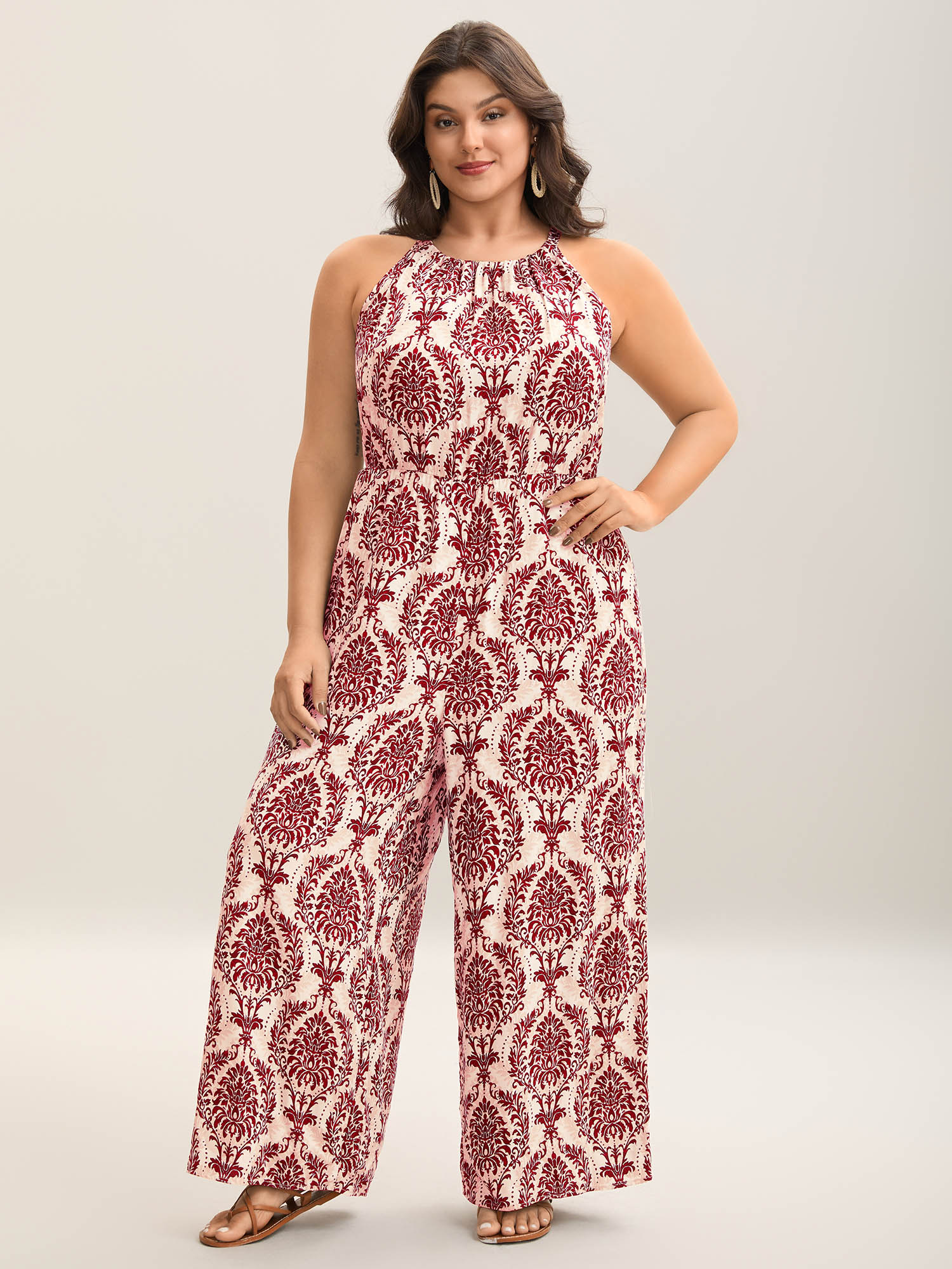 Side view of BloomChic Women's Plus Size Rayon Damask Print Stretchy Waist Jumpsuit Rust Vacation 10/M