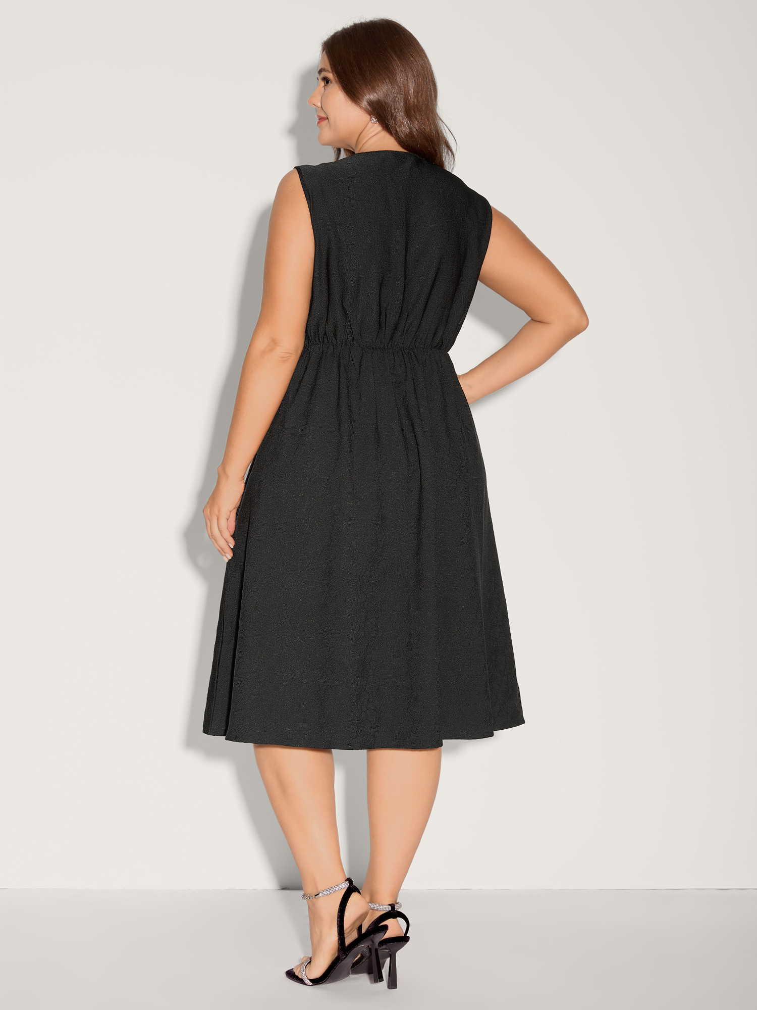 Side view of BloomChic Women's Plus Size Textured Waist-Cut Pleated Solid Midi Dress Black Party Midi Elastic Waist 14-16/1X