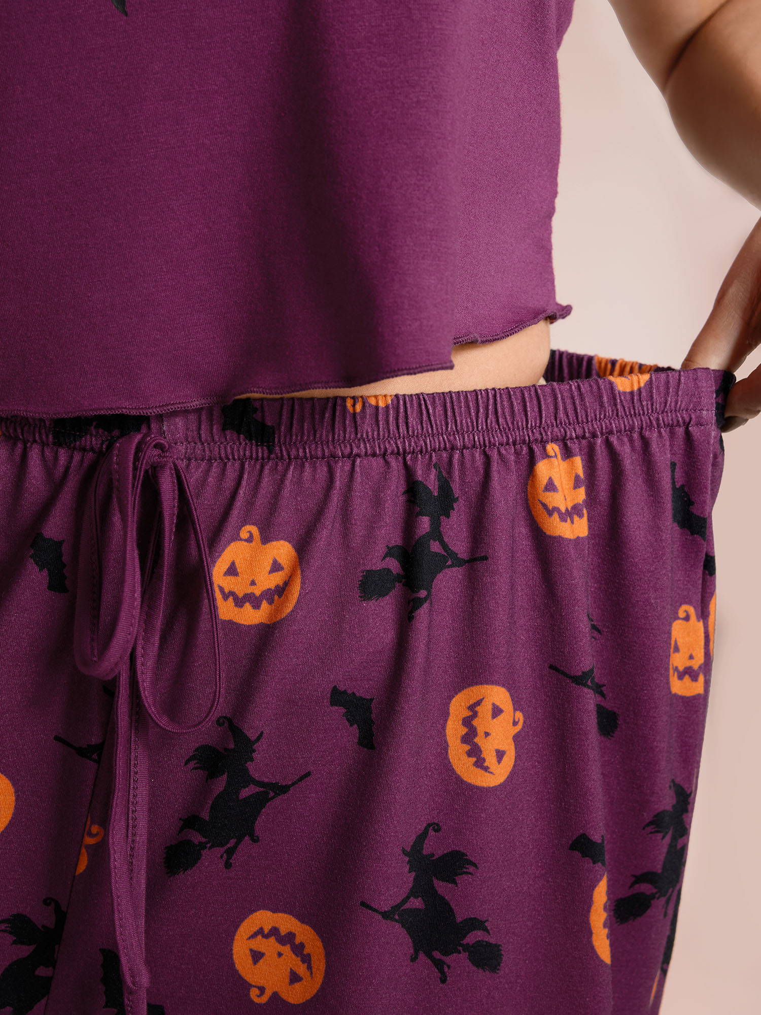 Side view of BloomChic Women's Plus Size Halloween Print Stretchy Waist Pajama Set Deeppurplered 10/M