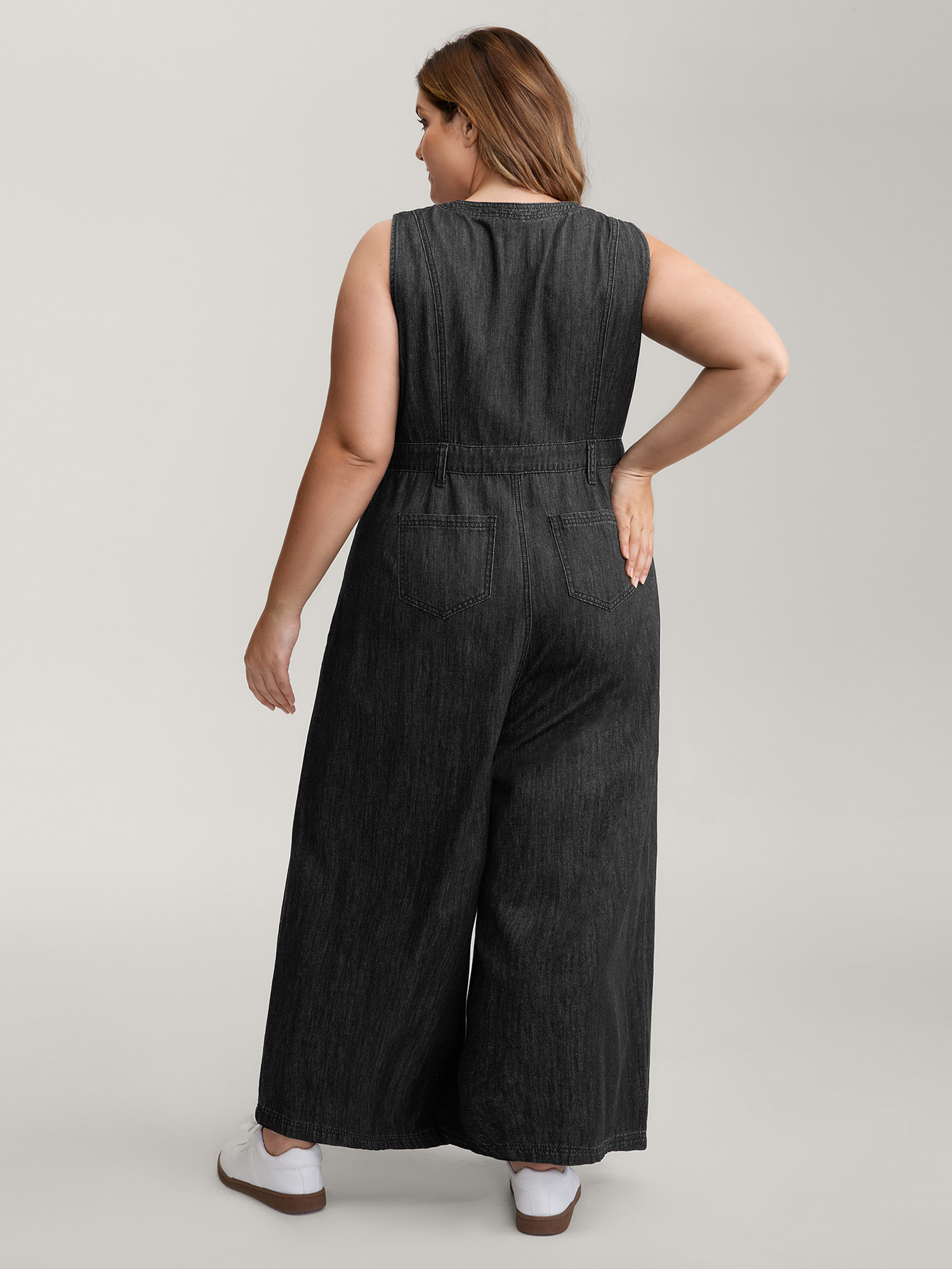 Side view of BloomChic Women's Plus Size Button Placket Pockets Denim Jumpsuit Acidwashblack Casual Button No stretch 26/4X