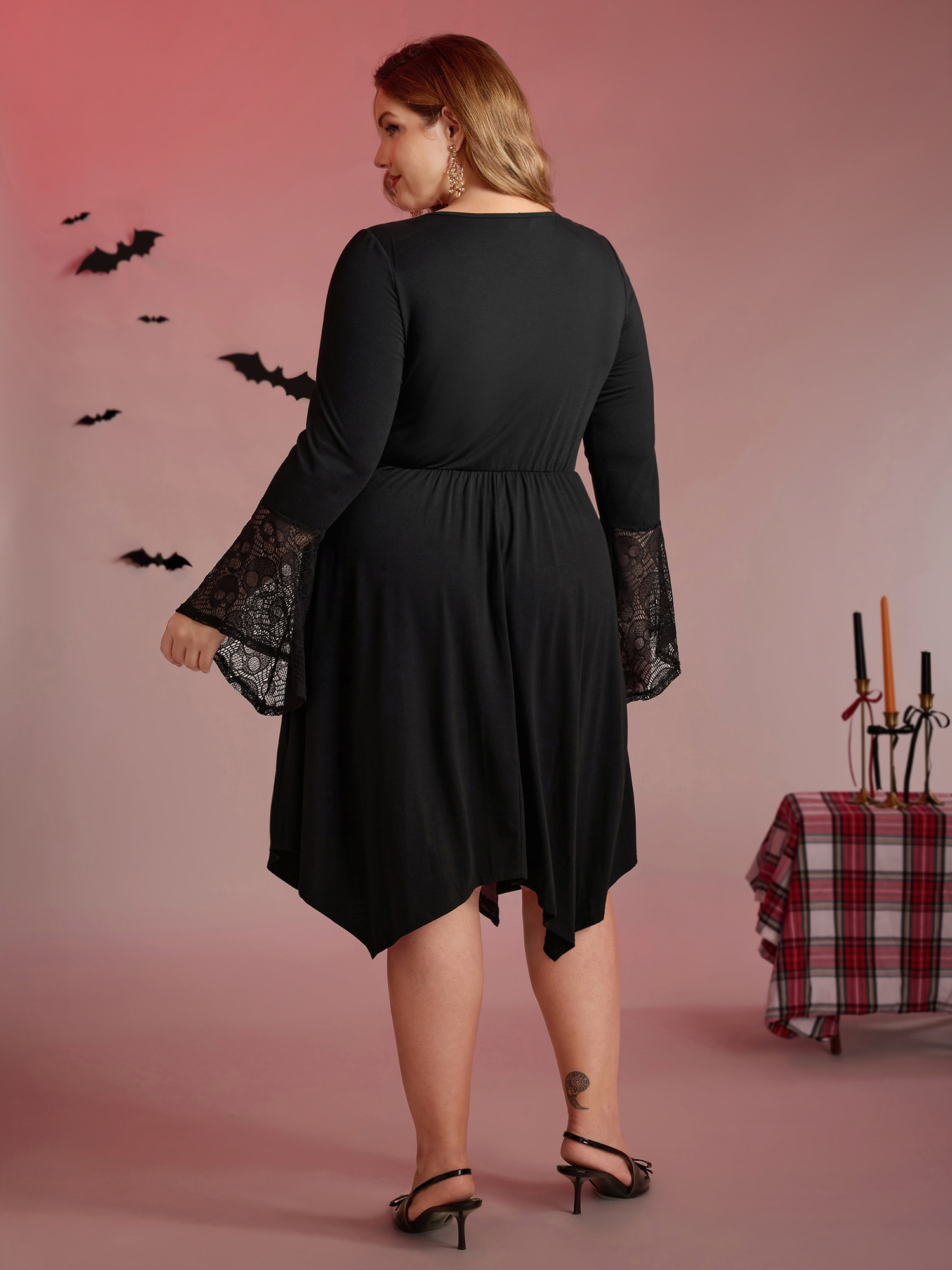 Side view of BloomChic Women's Plus Size Skull Wide-Waist Tie Contrast Midi Dress Black Party 14-16/1X
