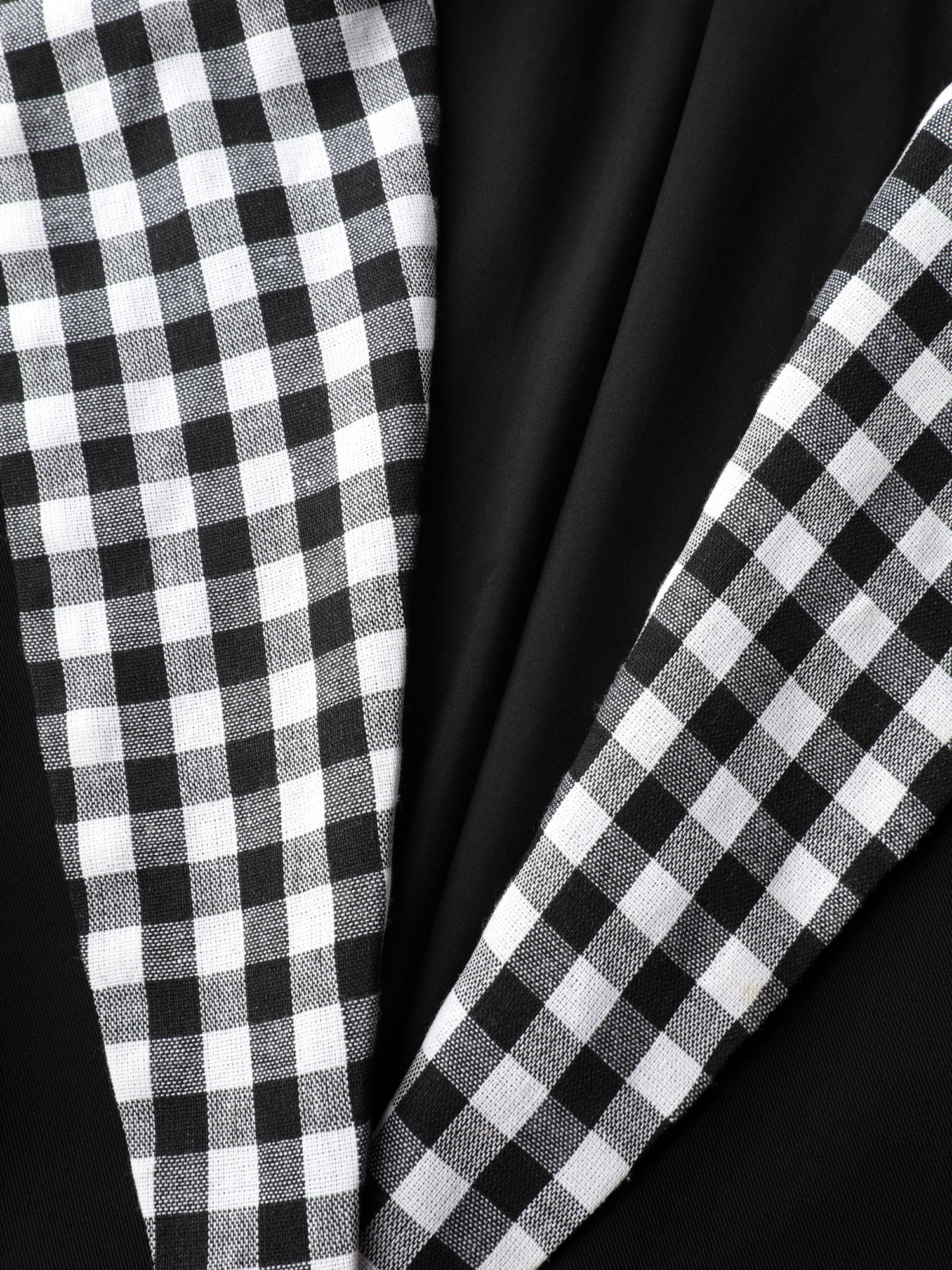 Side view of BloomChic Women's Plus Size Checkered Contrast Button Blazer Black Colorblock Sleeve 3/4 Sleeve 26/4X
