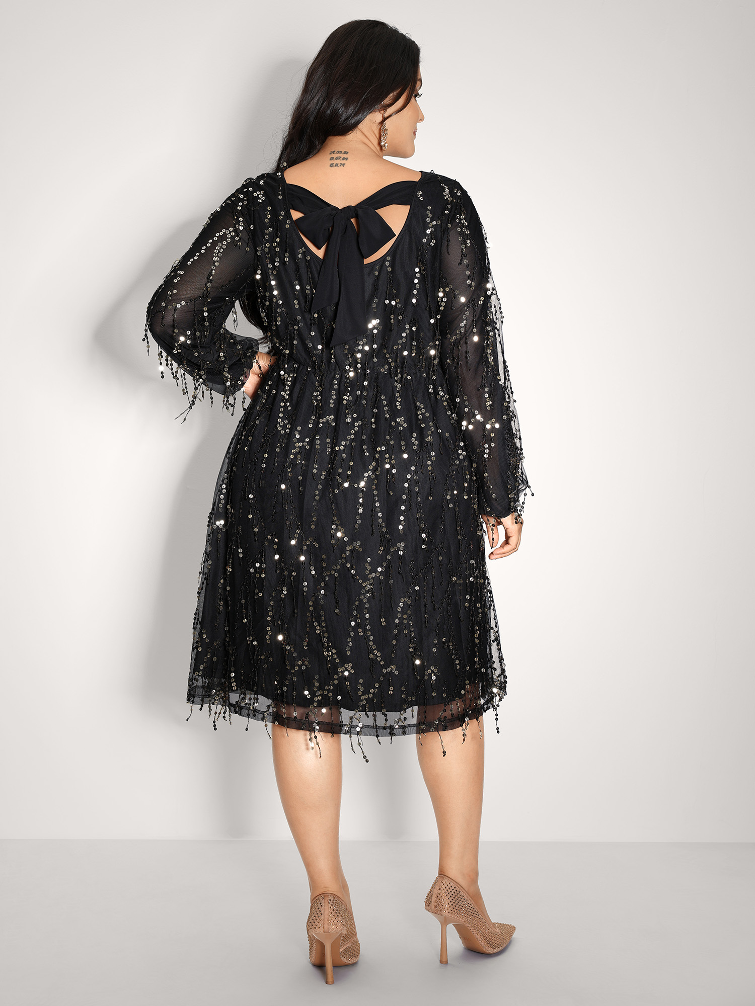 Side view of BloomChic Women's Plus Size Back Bow Tie Fringe Sequin Mini Dress Black Party Midi Ruched Round Neck 12/L