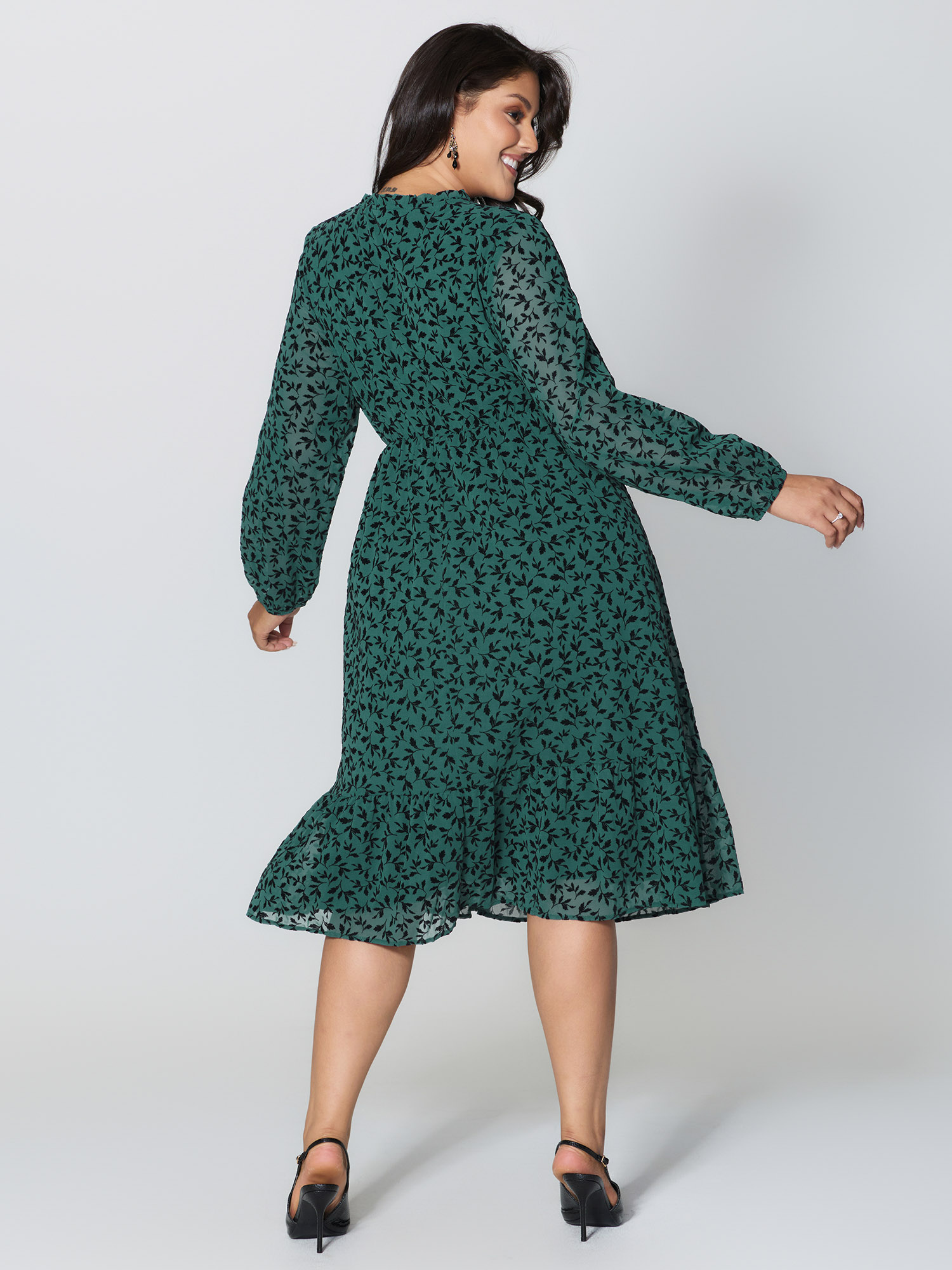 Side view of BloomChic Women's Plus Size Flocked Floral Shirred Ruffled Neck Midi Dress Teal Elegant Midi Ruched Round Neck 30/6X