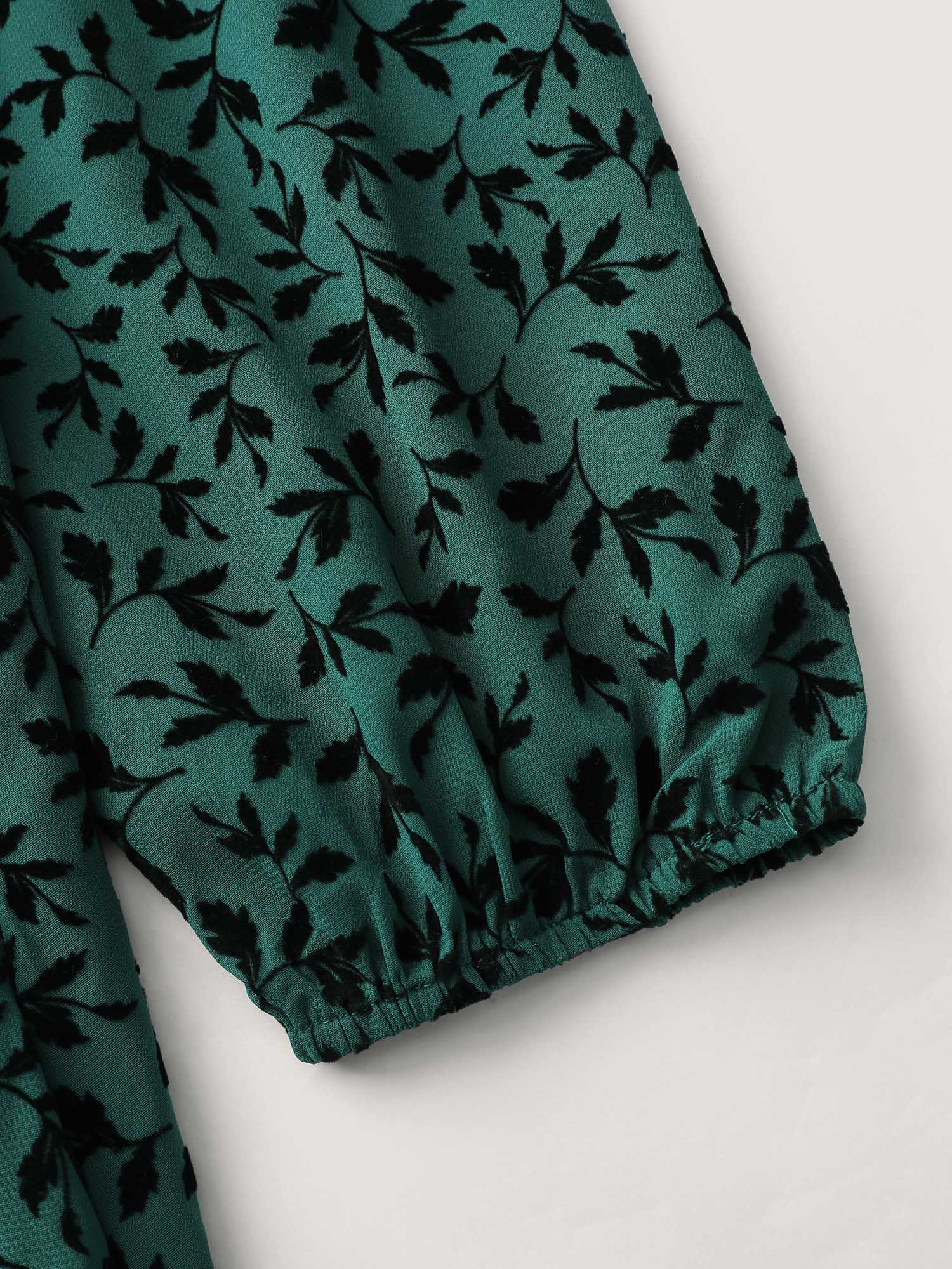Side view of BloomChic Women's Plus Size Flocked Floral Shirred Ruffled Neck Midi Dress Teal Elegant Midi Ruched Round Neck 30/6X