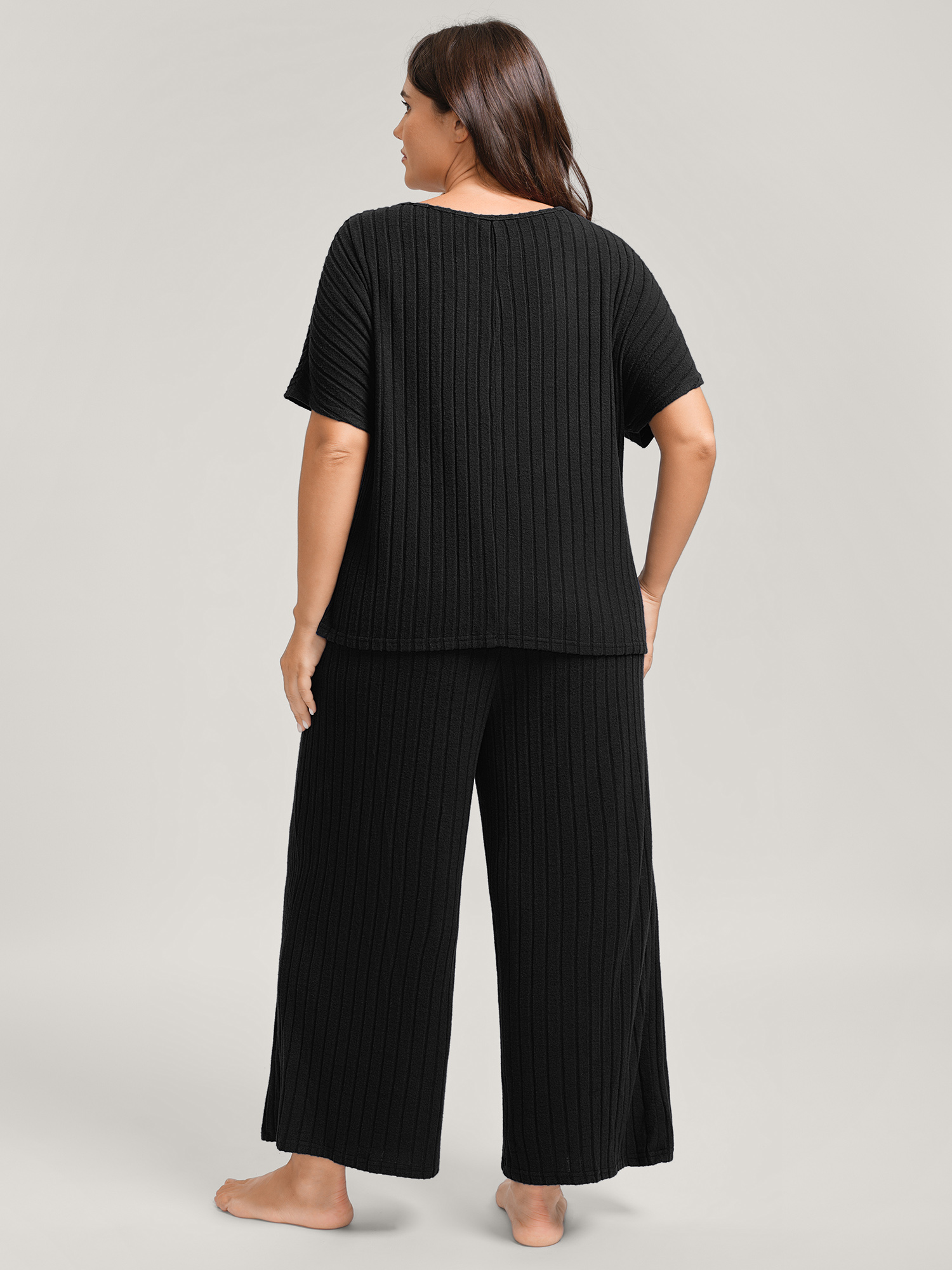 Side view of BloomChic Women's Plus Size Stretchy Pit Strip Solid Loungewear Set Black Solid Short sleeve Non 12/L