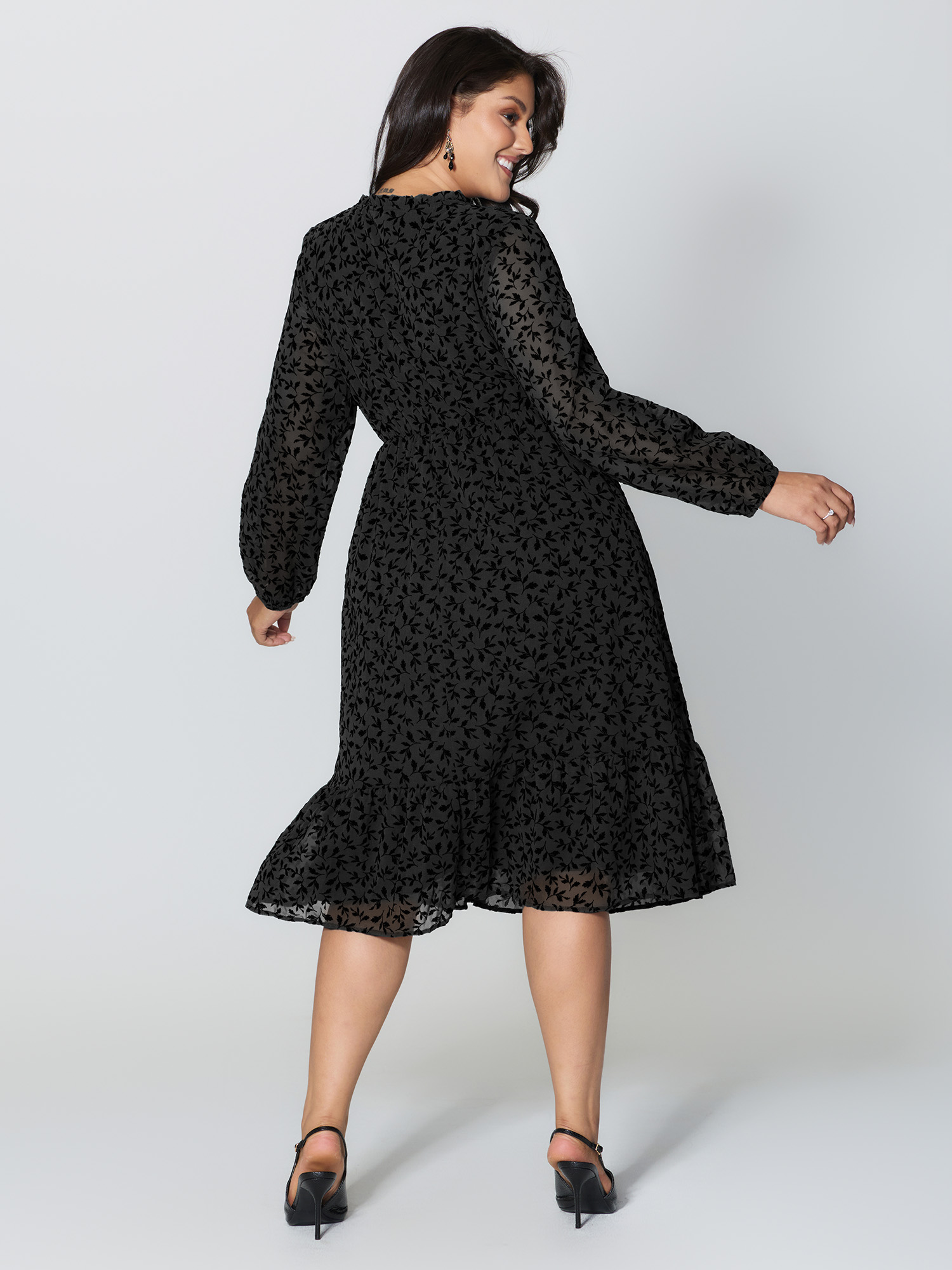 Side view of BloomChic Women's Plus Size Flocked Floral Shirred Ruffled Neck Midi Dress Black Elegant Midi Ruched Round Neck 26/4X