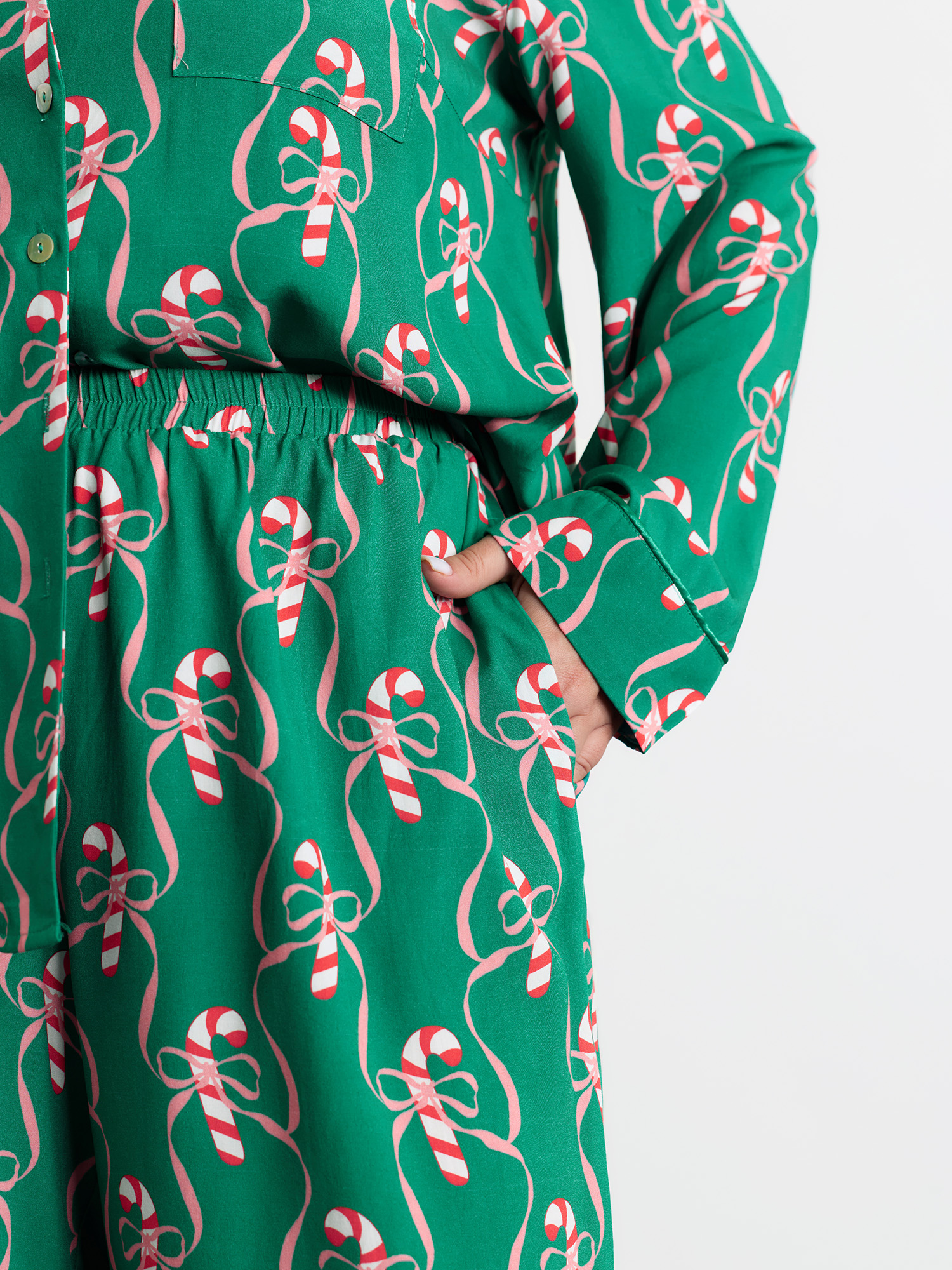 Side view of BloomChic Women's Plus Size Holiday Cheer Print Pockets Two-Piece Lounge Set Emerald Christmas Long Sleeve Non 18-20/2X