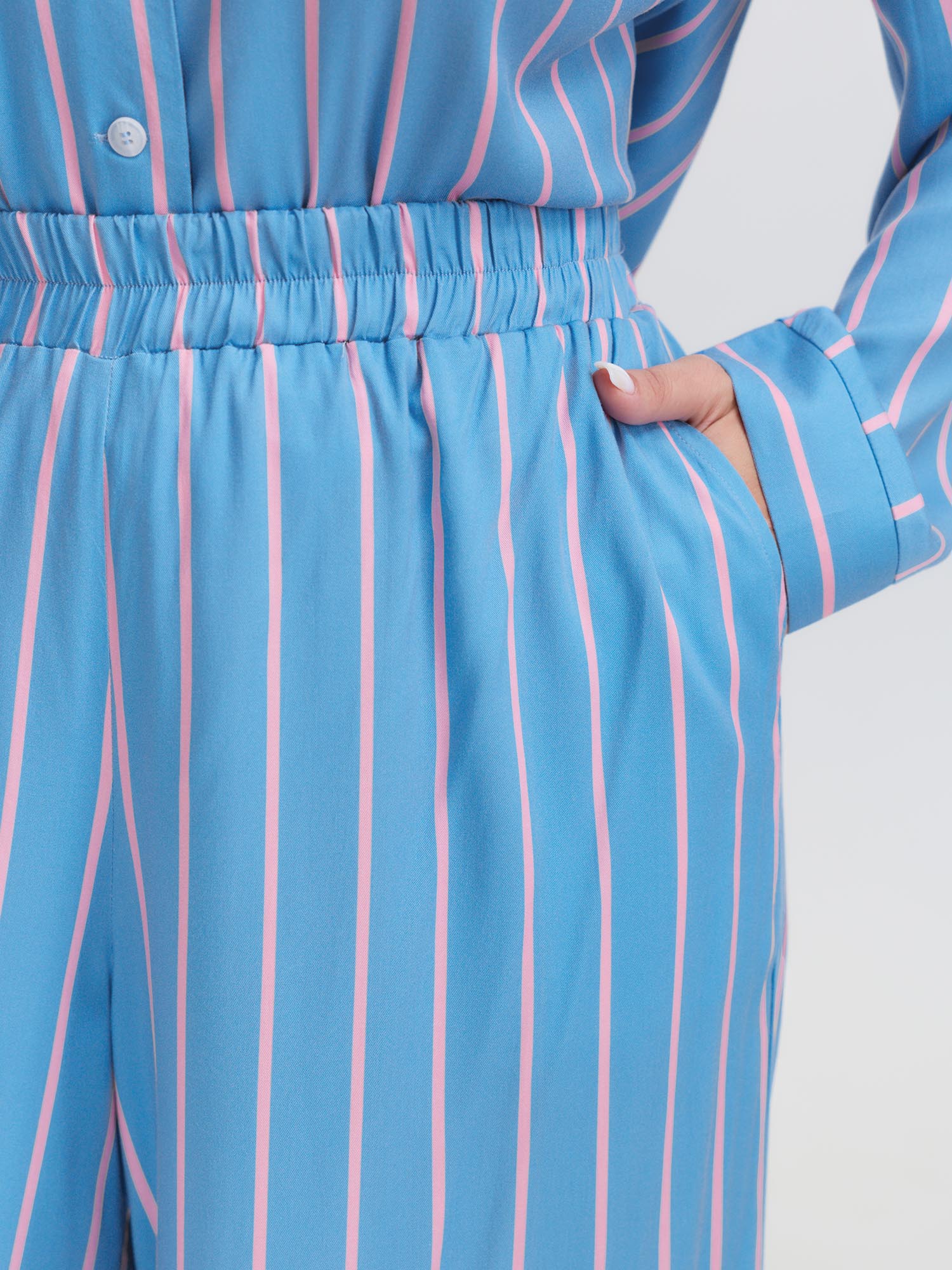 Side view of BloomChic Women's Plus Size Stripe Print Pockets Two-Piece Pajama Set LightBlue 10/M