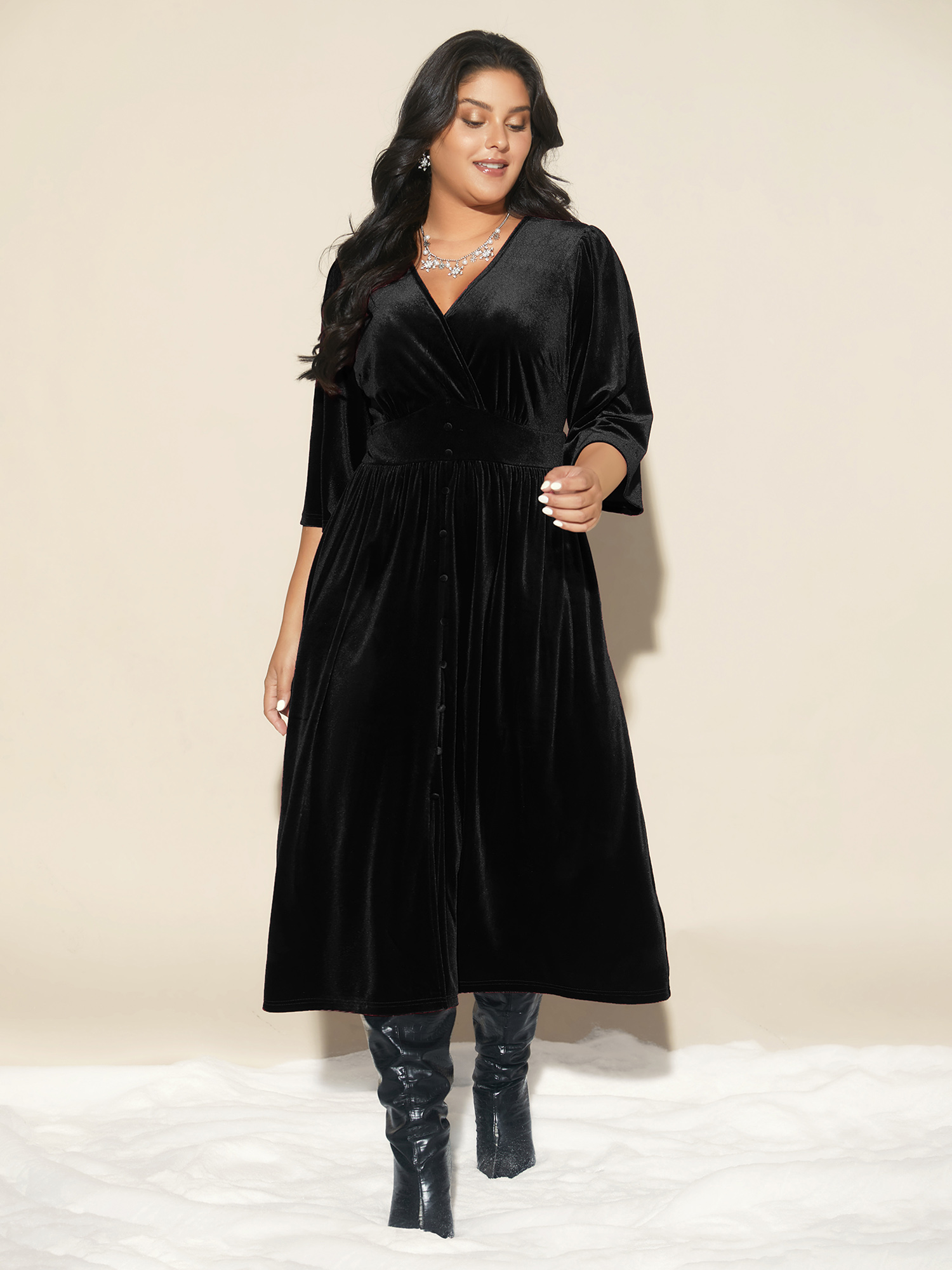 Side view of BloomChic Women's Plus Size Velvet Ruched Surplice Neckline Midi Dress Black Party Midi Smocked V-Neck 14-16/1X