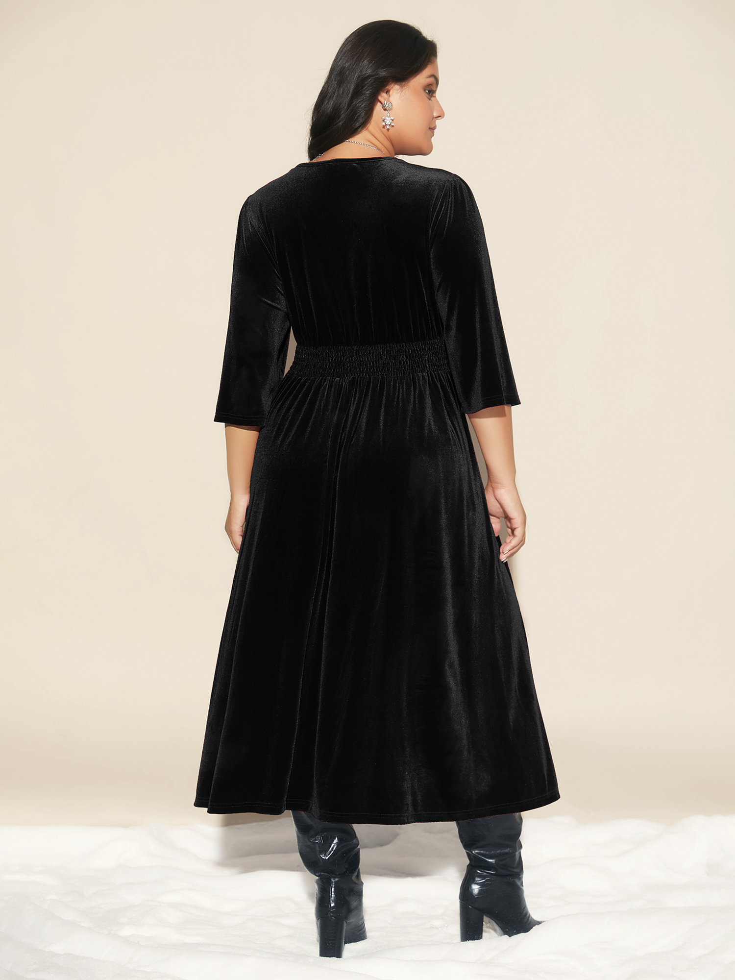 Side view of BloomChic Women's Plus Size Velvet Ruched Surplice Neckline Midi Dress Black Party Midi Smocked V-Neck 14-16/1X