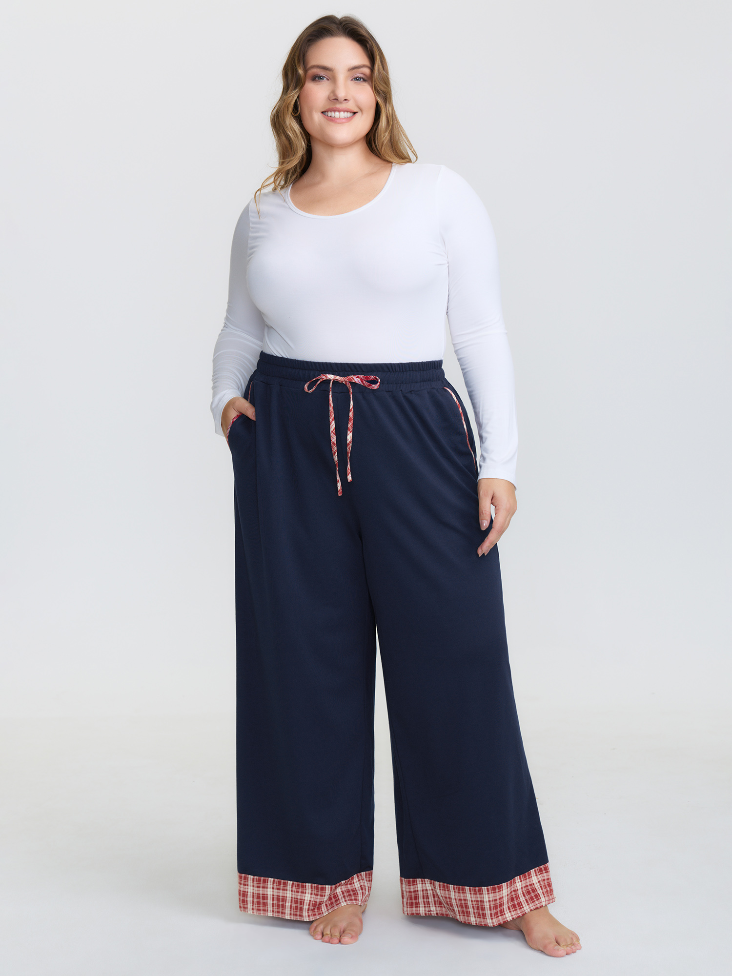 Side view of BloomChic Women's Plus Size Gingham Edges Stretchy Drawstring Lounge Bottoms Indigo Tall 30/6X