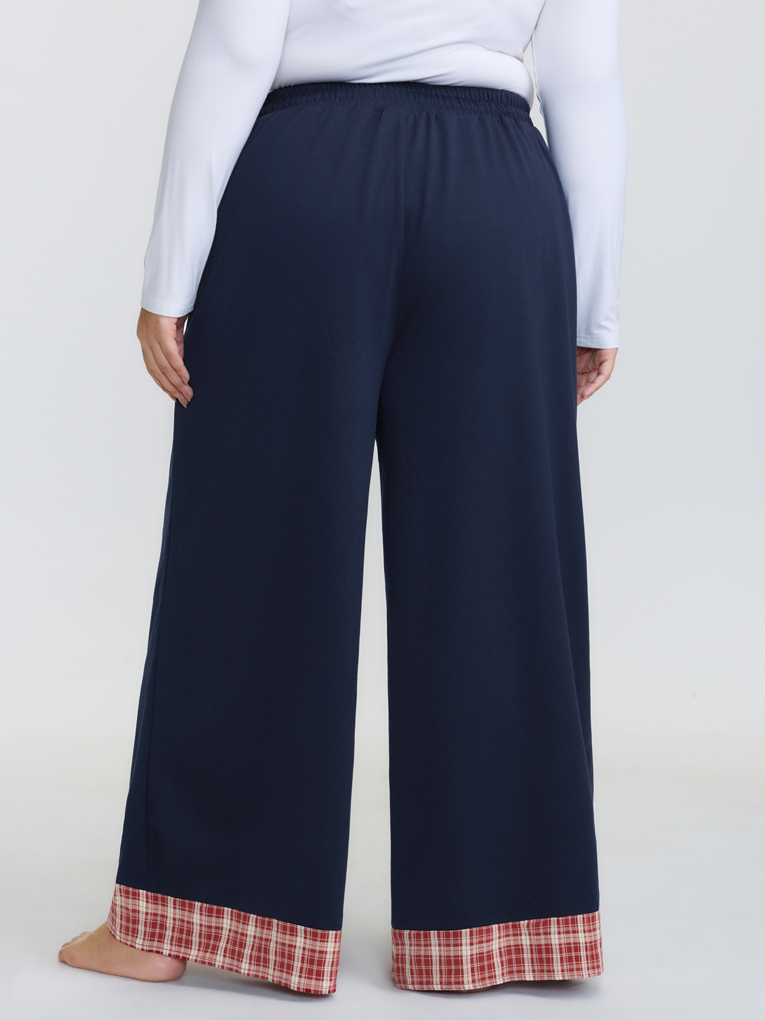 Side view of BloomChic Women's Plus Size Gingham Edges Stretchy Drawstring Lounge Bottoms Indigo Tall 30/6X