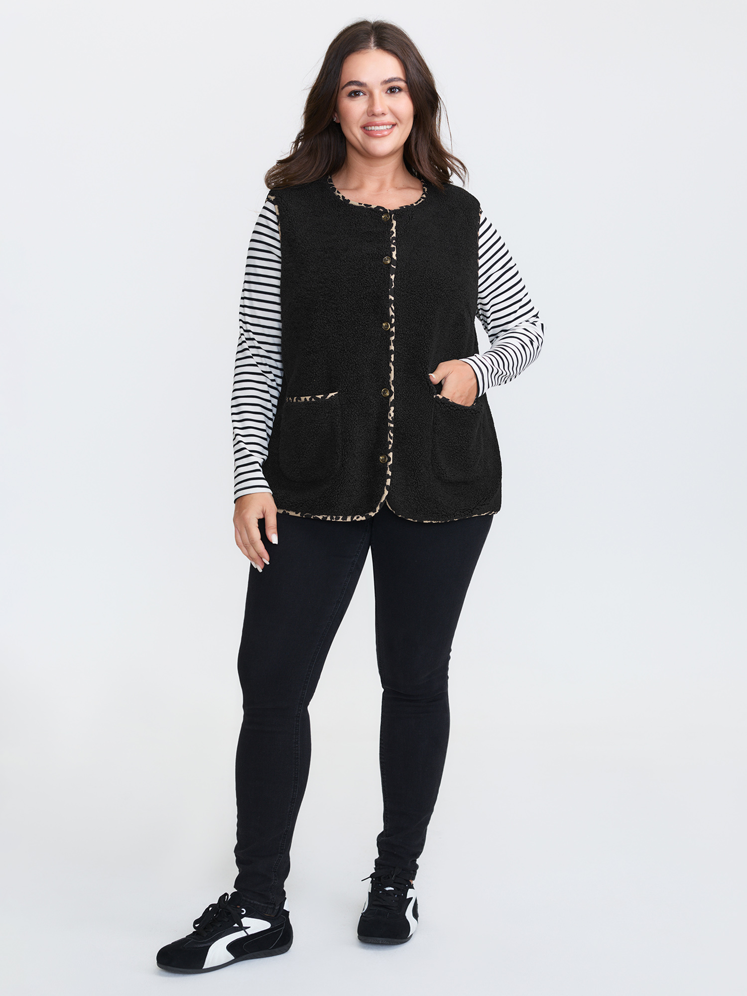 Side view of BloomChic Women's Plus Size Faux Shearling Patchwork Leopard Edge Vest Black Colorblock 14-16/1X