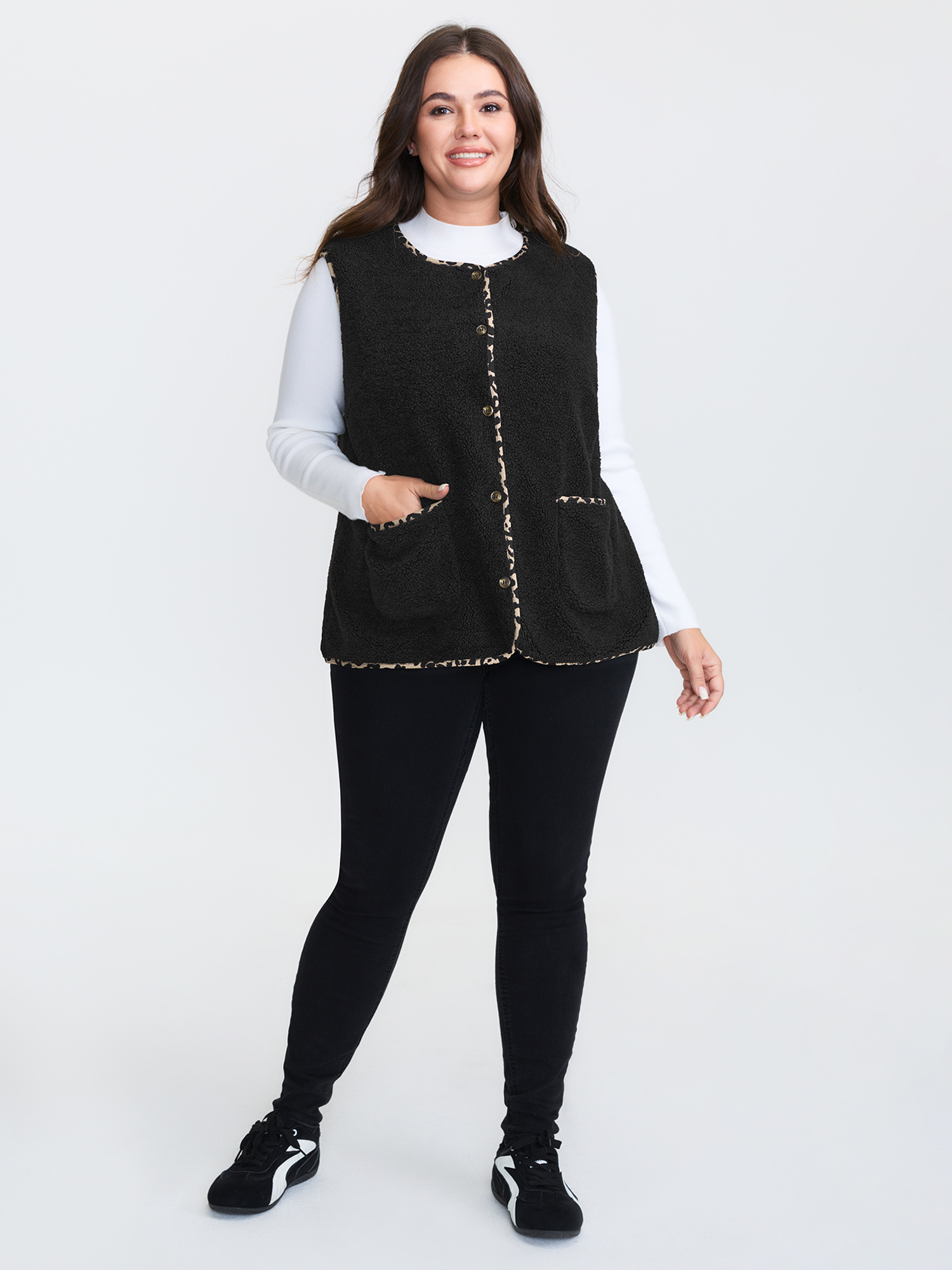 Side view of BloomChic Women's Plus Size Faux Shearling Patchwork Leopard Edge Vest Black Colorblock 14-16/1X