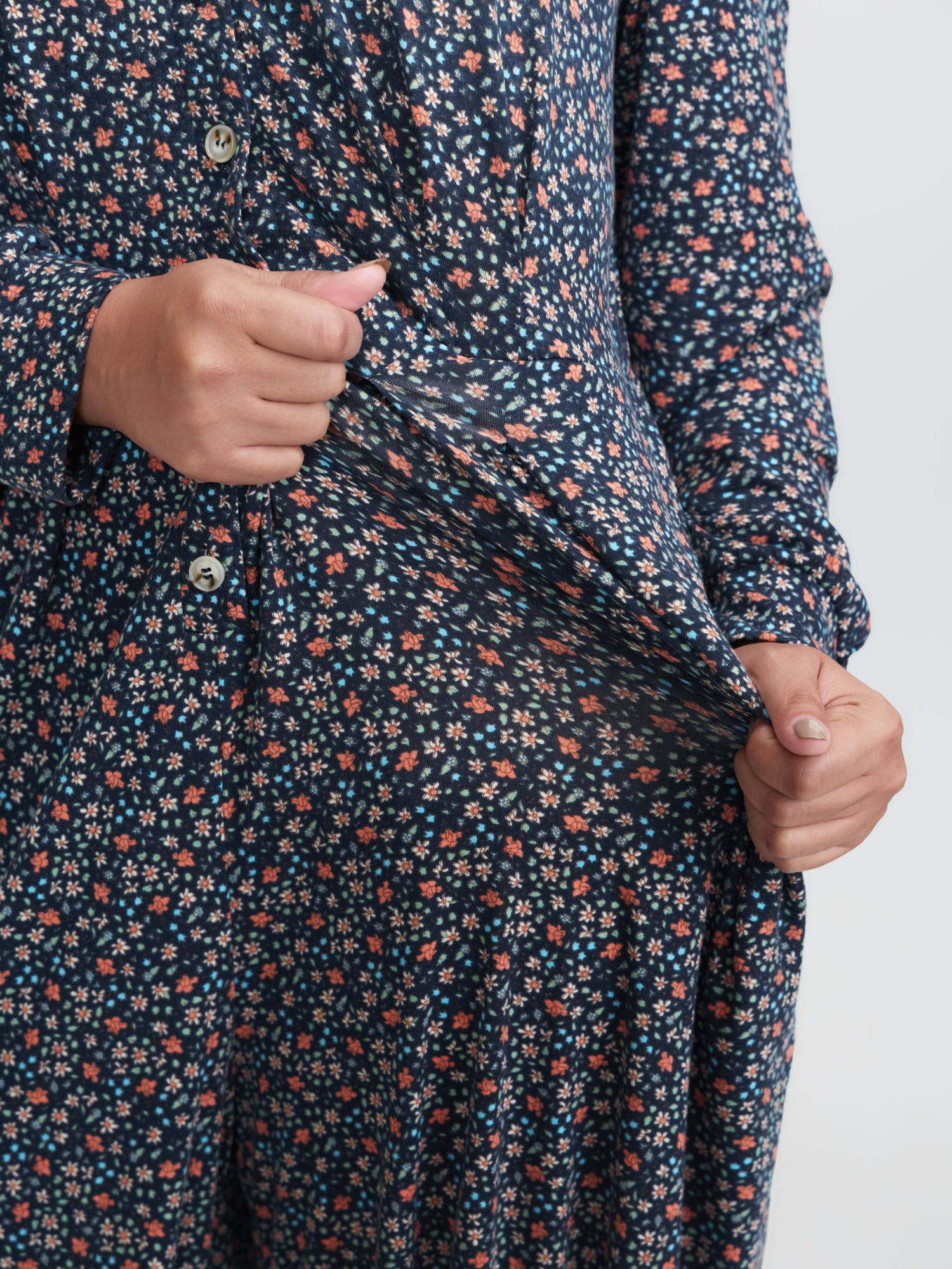 Side view of BloomChic Women's Plus Size Floral Print V-Neck Button Front Lounge Jumpsuit Indigo Natural Flowers Maxi 28/5X