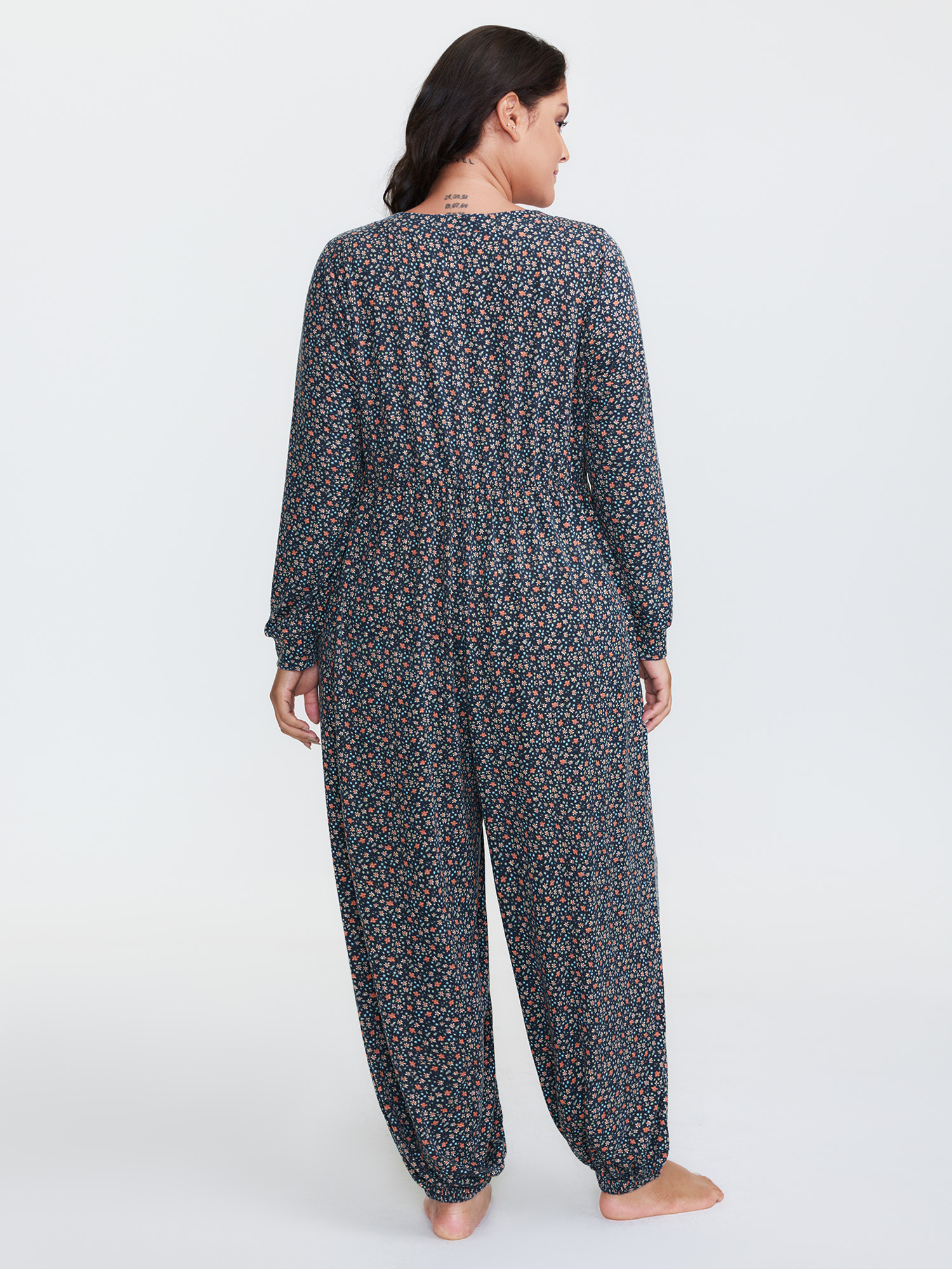 Side view of BloomChic Women's Plus Size Floral Print V-Neck Button Front Lounge Jumpsuit Indigo Natural Flowers Maxi 28/5X