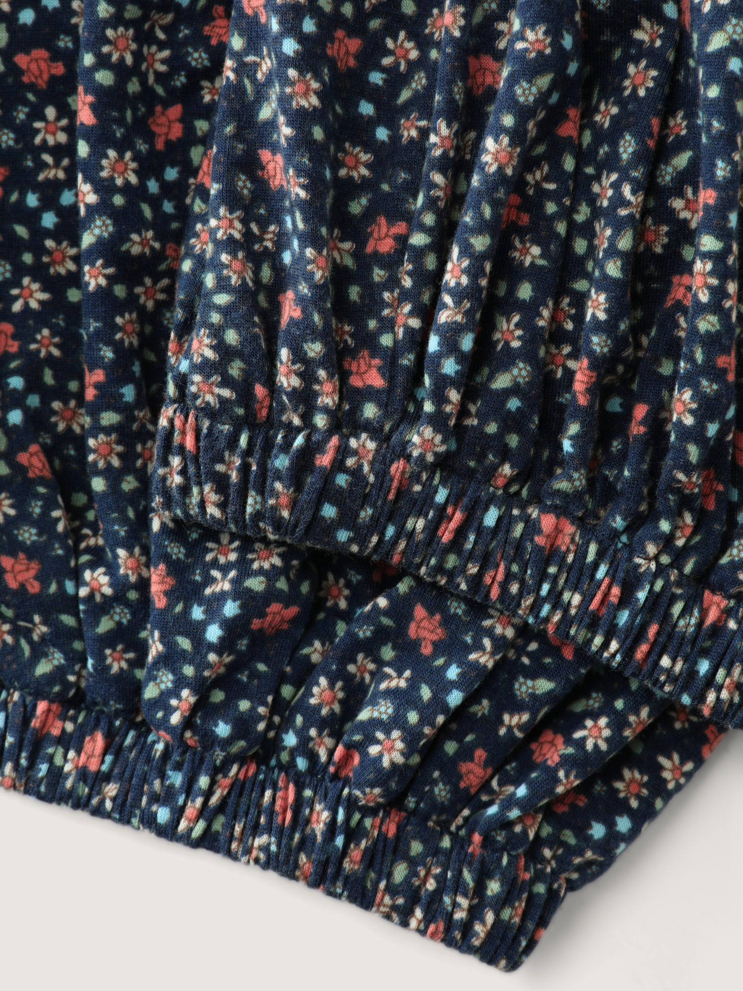 Side view of BloomChic Women's Plus Size Floral Print V-Neck Button Front Lounge Jumpsuit Indigo Natural Flowers Maxi 28/5X