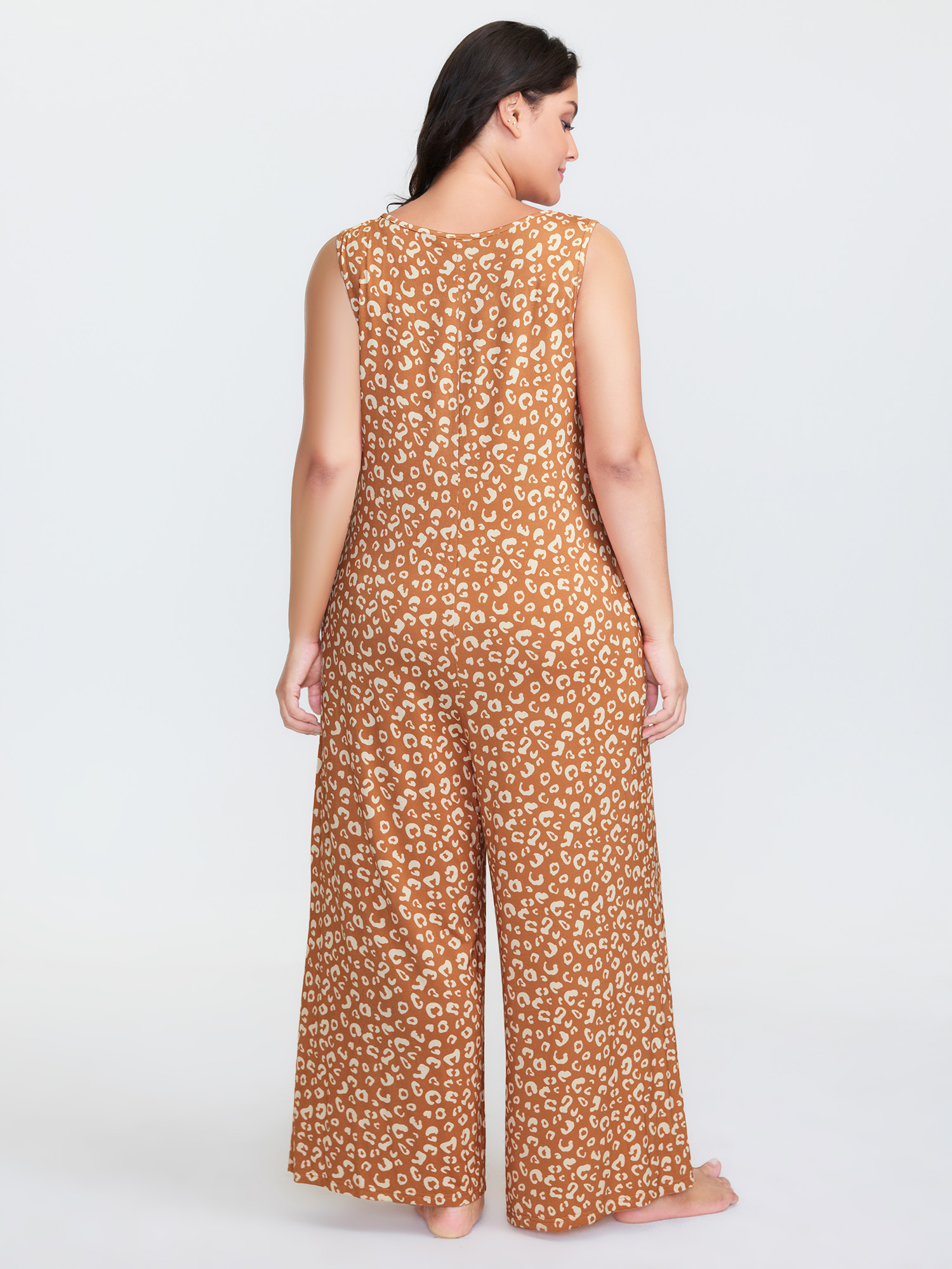 Side view of BloomChic Women's Plus Size Leopard Print Sleeveless Button Front Lounge jumpsuit Yellowishbrown Maxi 26/4X