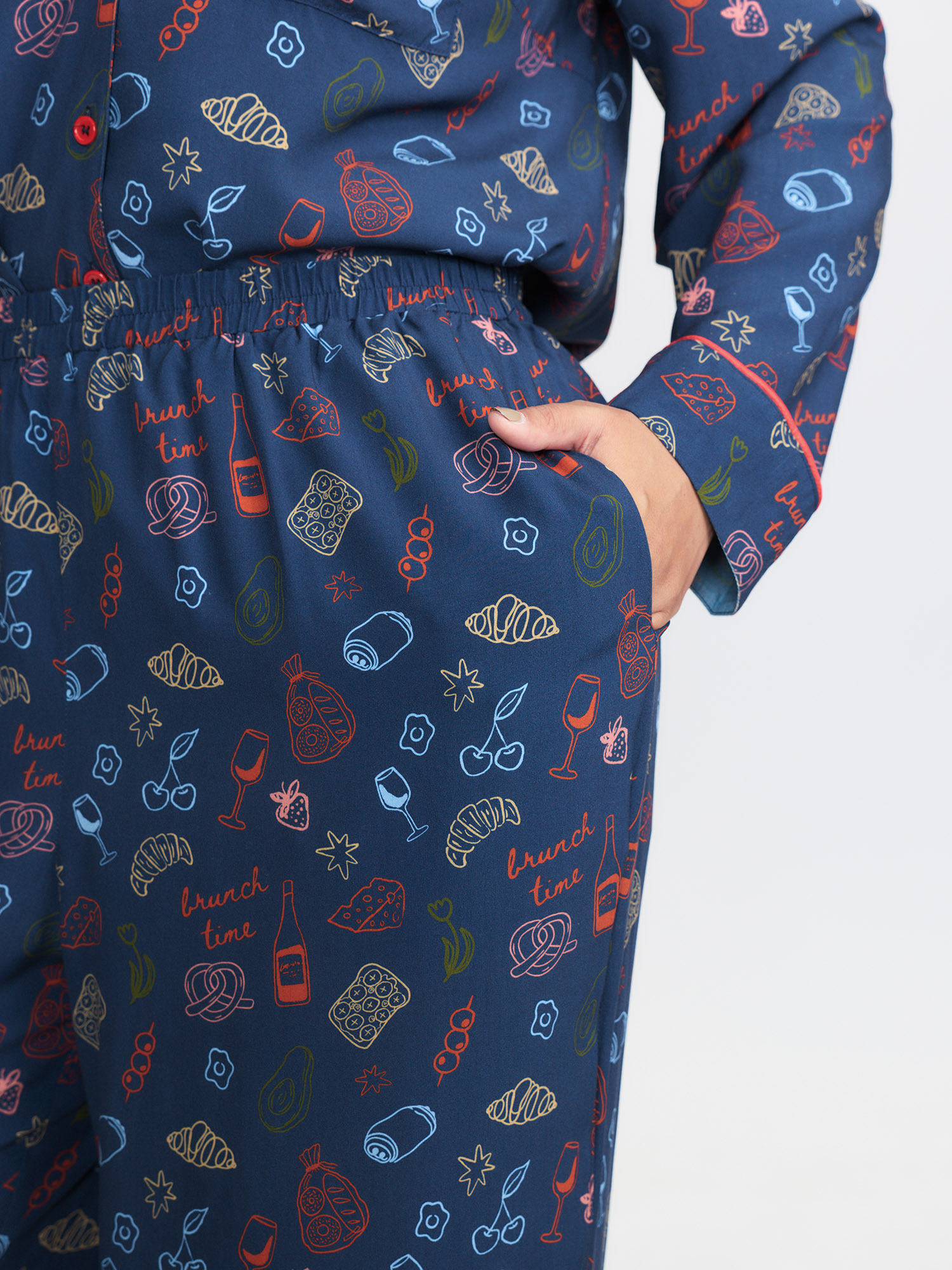 Side view of BloomChic Women's Plus Size Breakfast Print Elastic Waist Pocket Pajama Bottoms Indigo Fruit and vegetable print Knee Woven ribbon&lace trim 26/4X