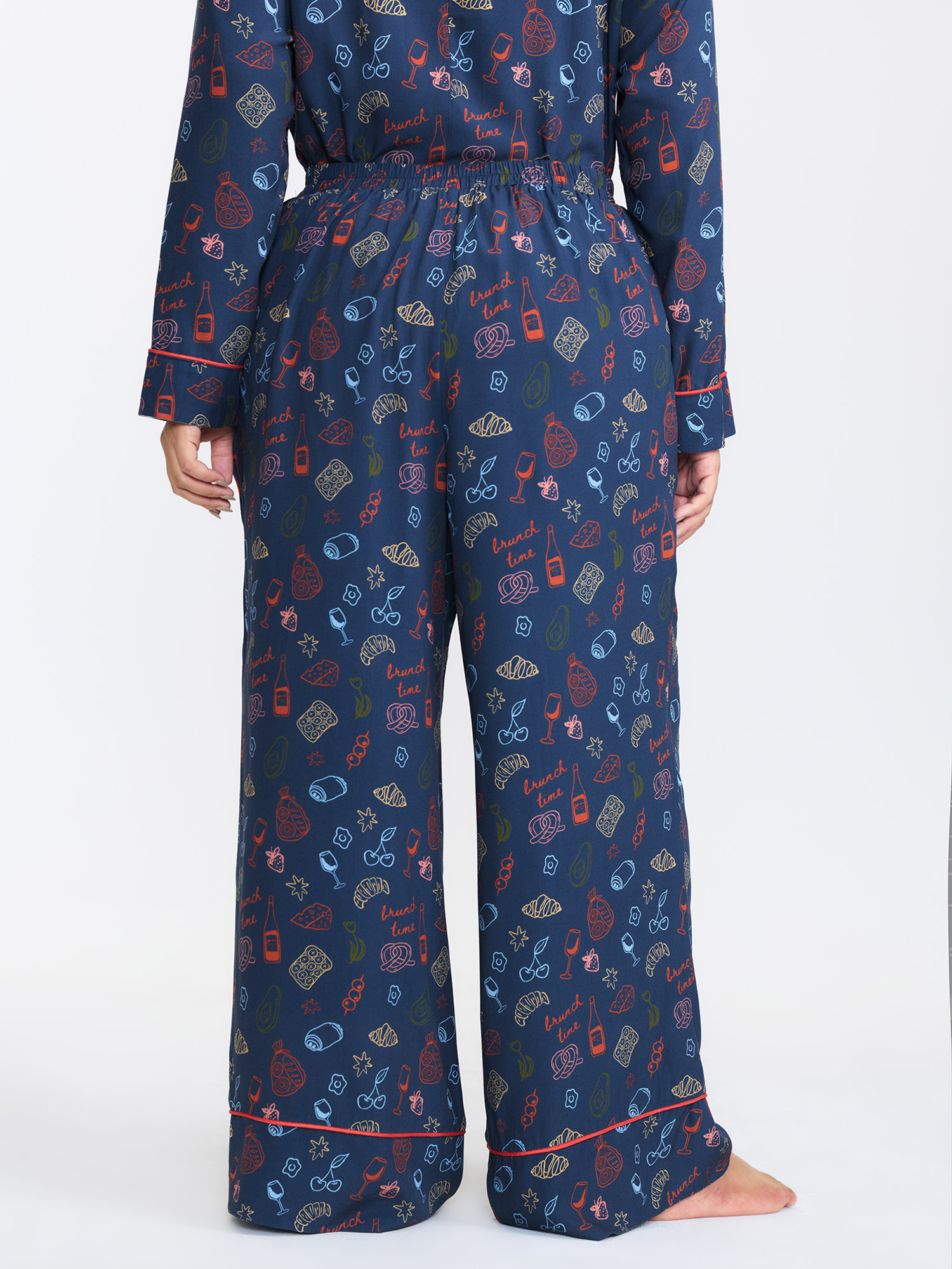 Side view of BloomChic Women's Plus Size Breakfast Print Elastic Waist Pocket Pajama Bottoms Indigo Fruit and vegetable print Knee Woven ribbon&lace trim 26/4X