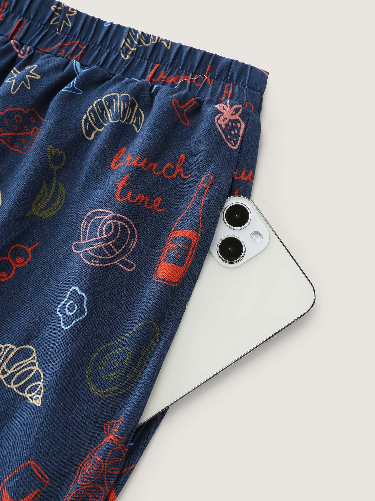 Side view of BloomChic Women's Plus Size Breakfast Print Elastic Waist Pocket Pajama Bottoms Indigo Fruit and vegetable print Knee Woven ribbon&lace trim 26/4X