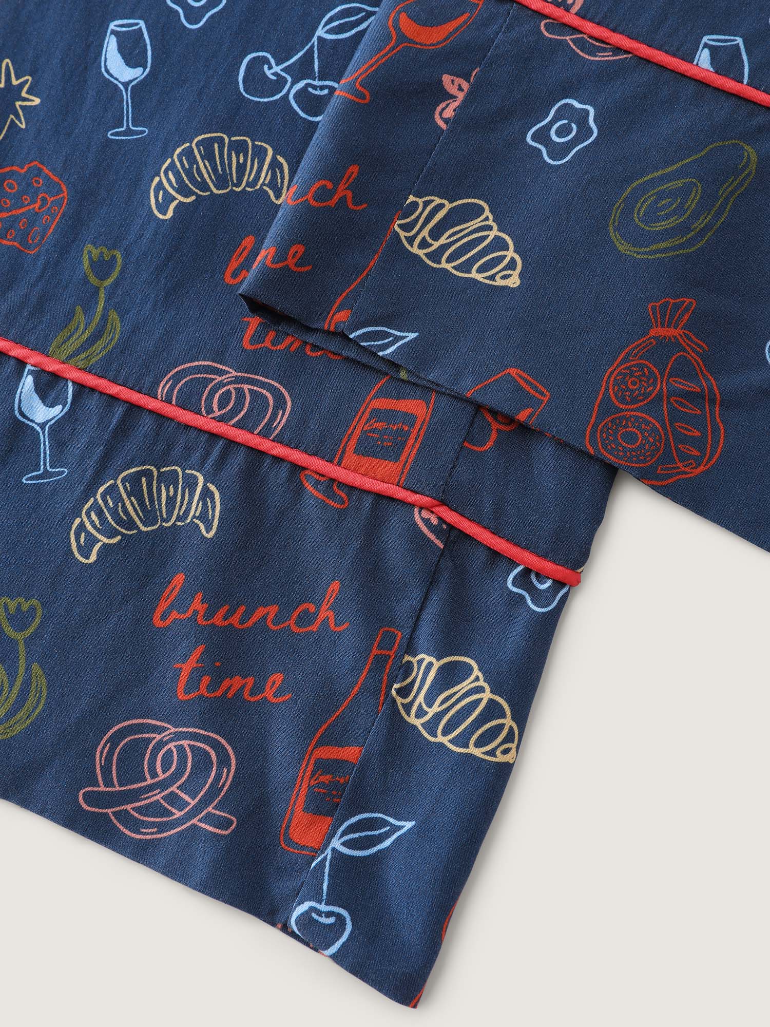 Side view of BloomChic Women's Plus Size Breakfast Print Elastic Waist Pocket Pajama Bottoms Indigo Fruit and vegetable print Knee Woven ribbon&lace trim 26/4X