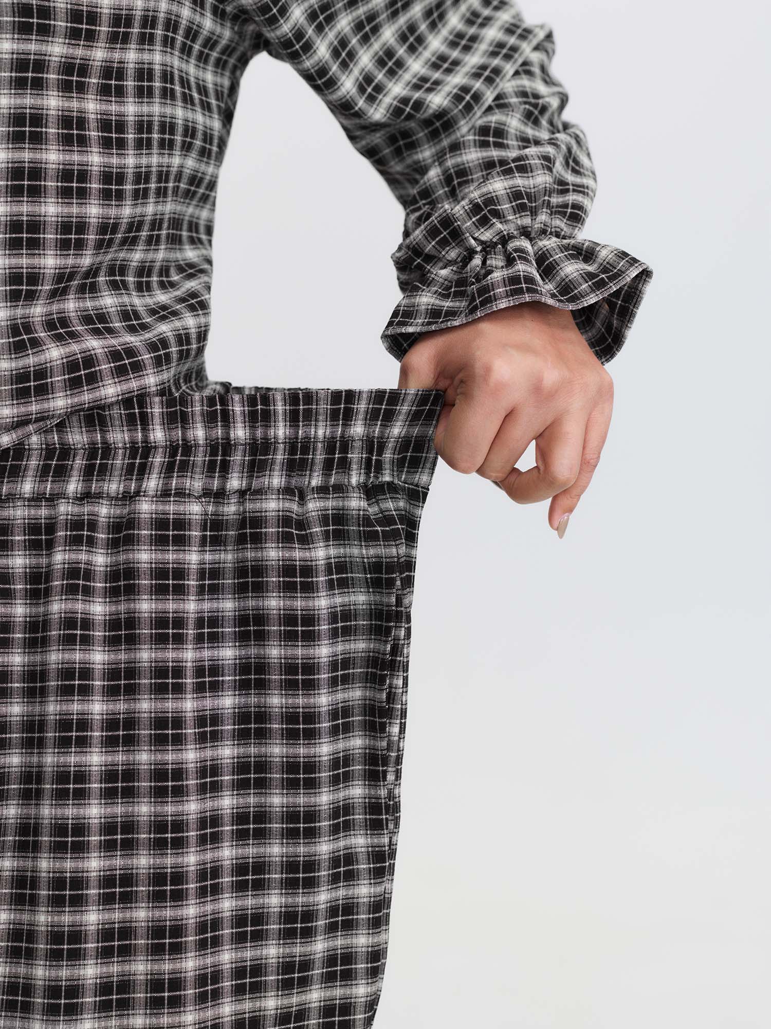 Side view of BloomChic Women's Plus Size Gingham Print Ruffled Hem Co-Ord Pajama Set BlackFlower not graphics 12/L
