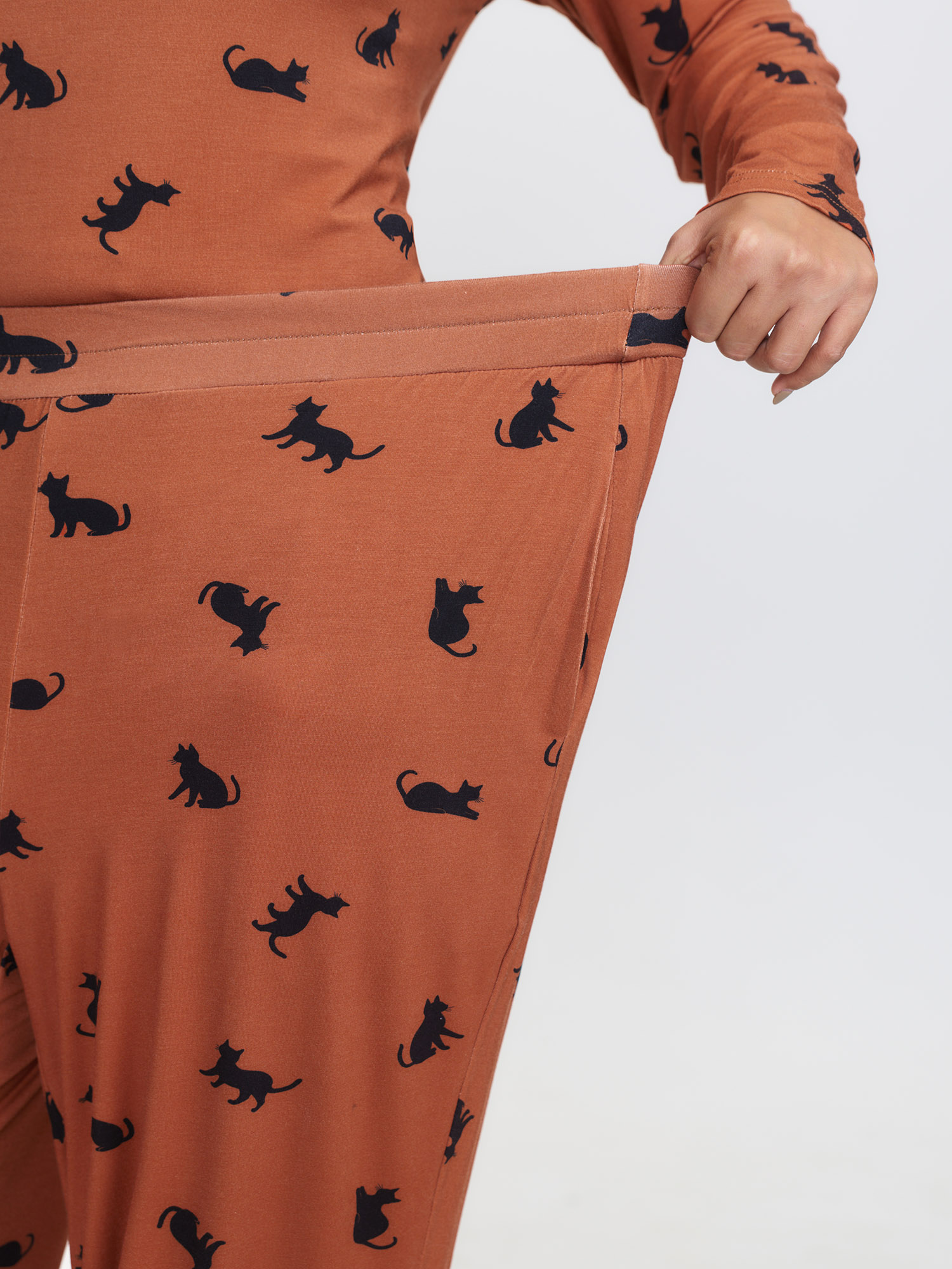 Side view of BloomChic Women's Plus Size Midnight Cat Print Stretchy Lounge Bottoms Yellowishbrown 10/M