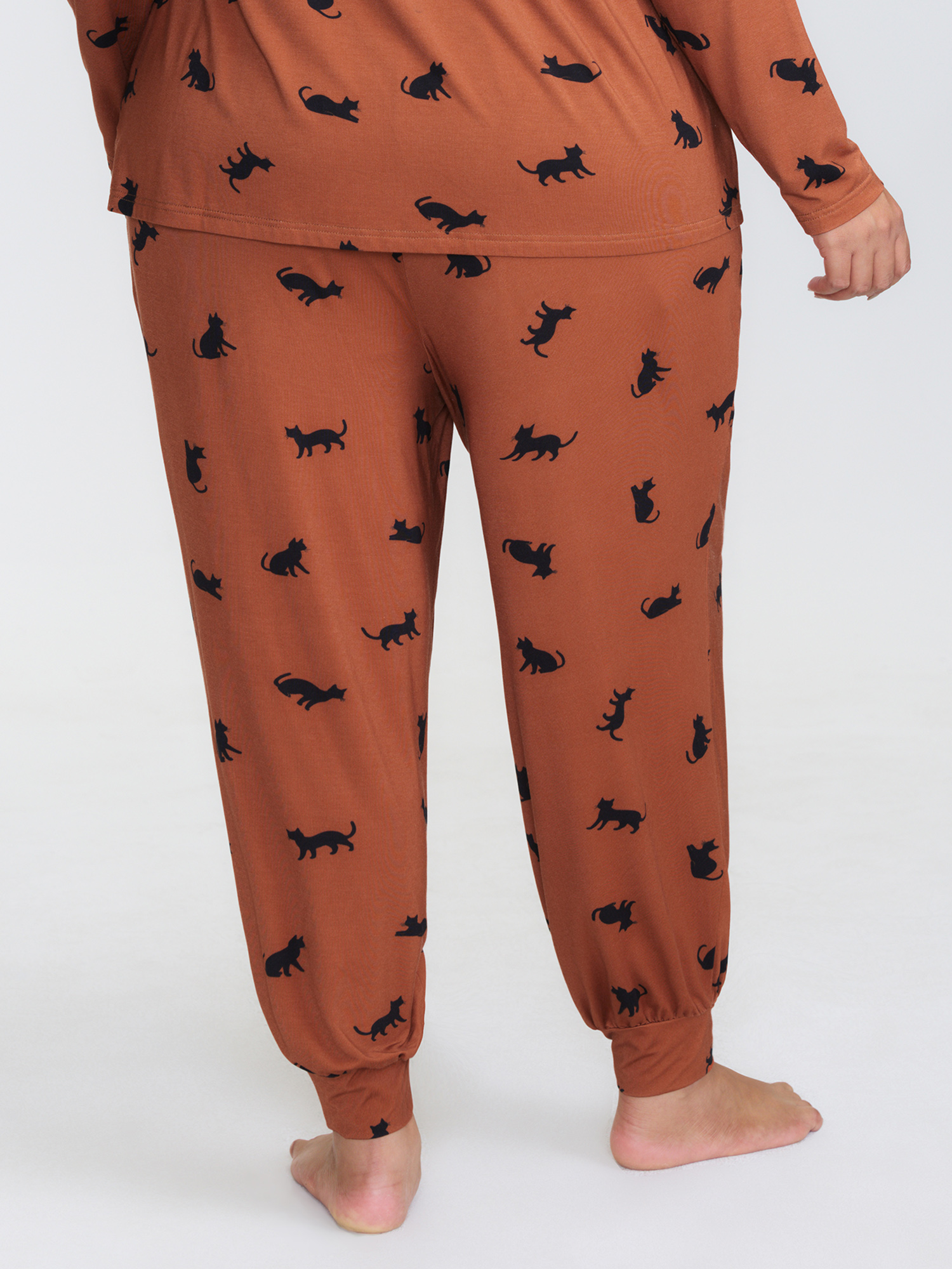 Side view of BloomChic Women's Plus Size Midnight Cat Print Stretchy Lounge Bottoms Yellowishbrown 10/M