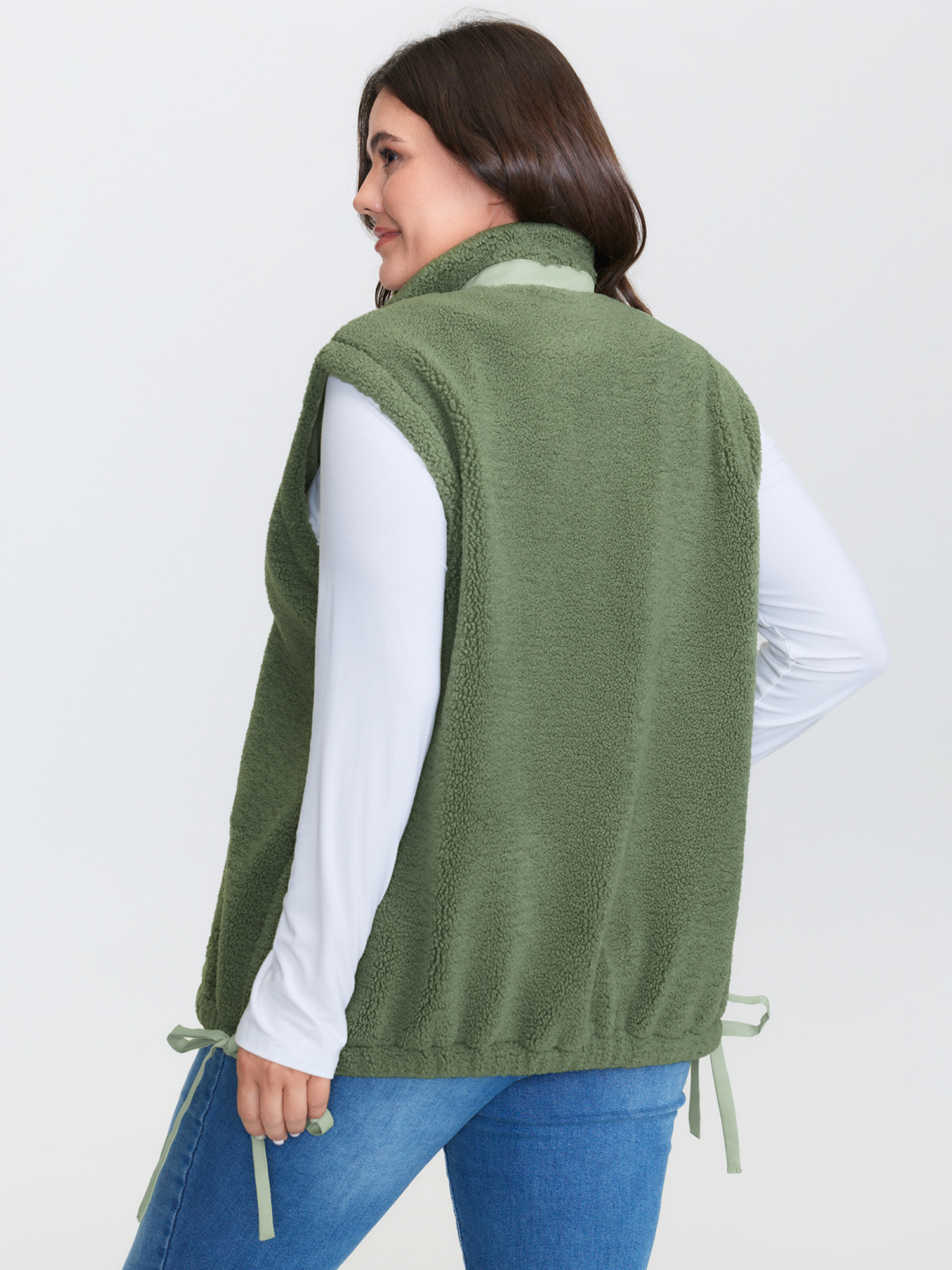 Side view of BloomChic Women's Plus Size Warm & Cozy Textured Pockets Vest Sage Bowknot 14-16/1X