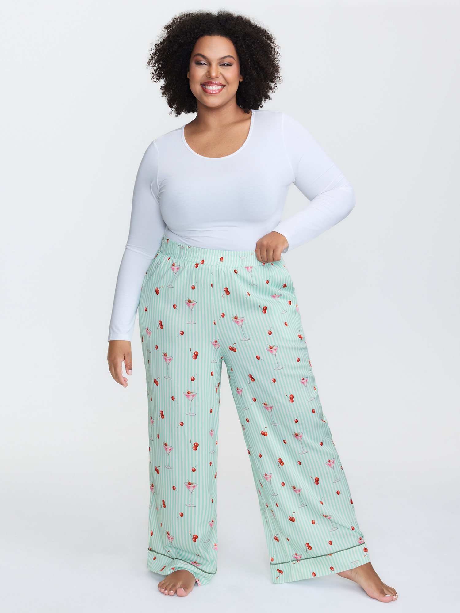 Side view of BloomChic Women's Plus Size Cherry Print Elastic Waist Pockets Pajama Bottoms Multicolor Fruit Smocked Relaxed Fit 26/4X