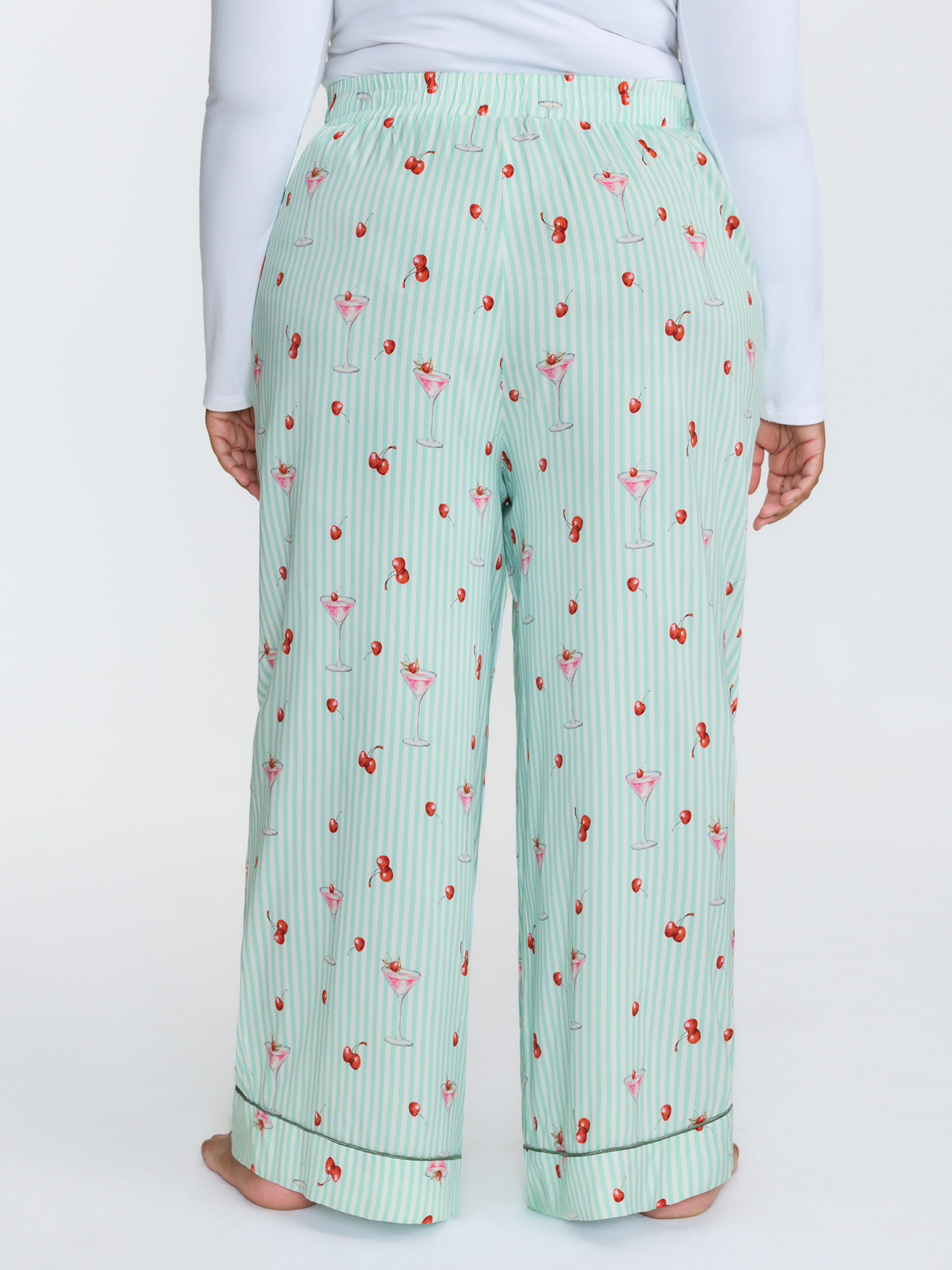 Side view of BloomChic Women's Plus Size Cherry Print Elastic Waist Pockets Pajama Bottoms Multicolor Fruit Smocked Relaxed Fit 26/4X
