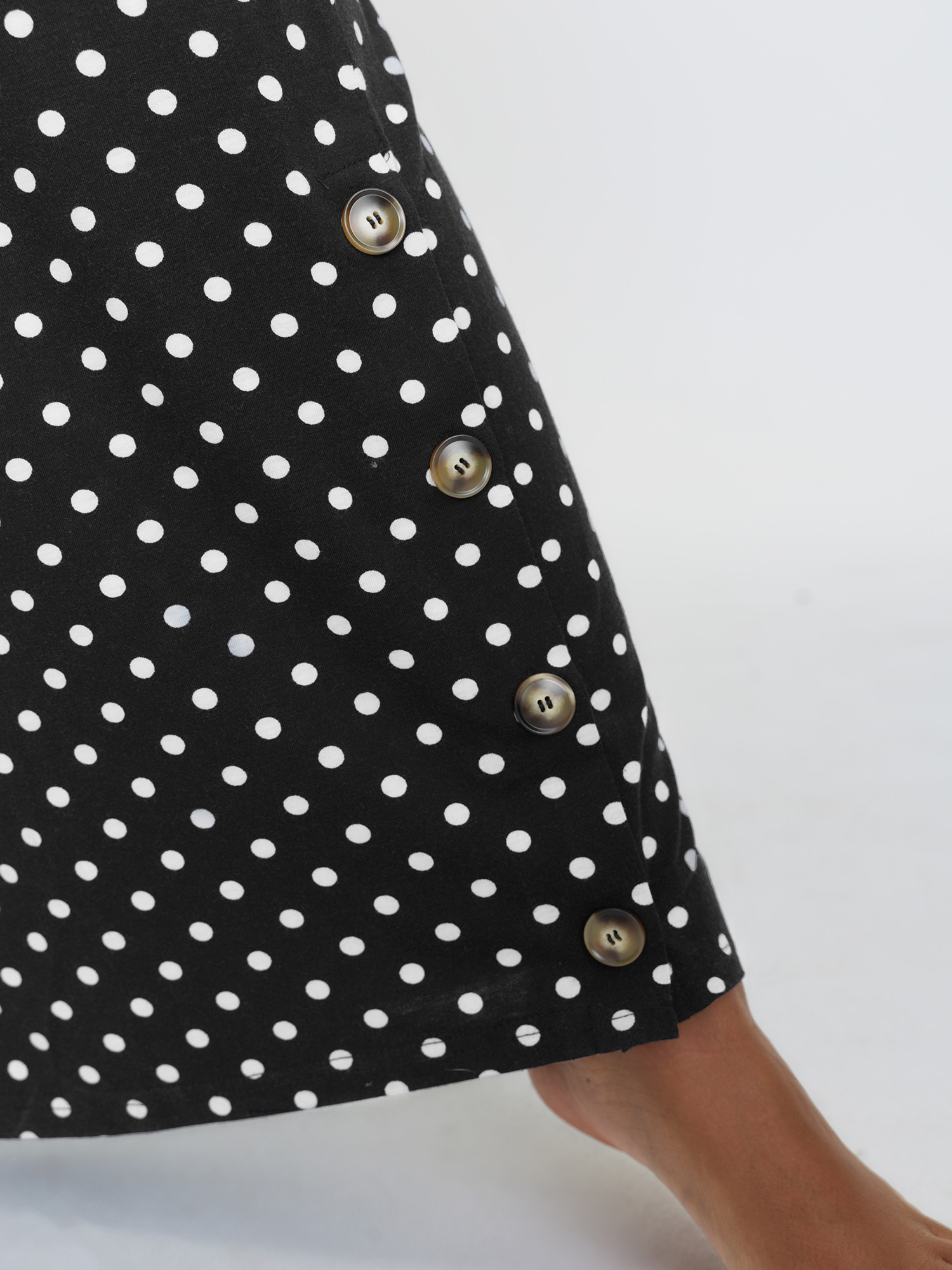 Side view of BloomChic Women's Plus Size Stretchy Polka Dots Lounge Jumpsuit Black Maxi 10/M