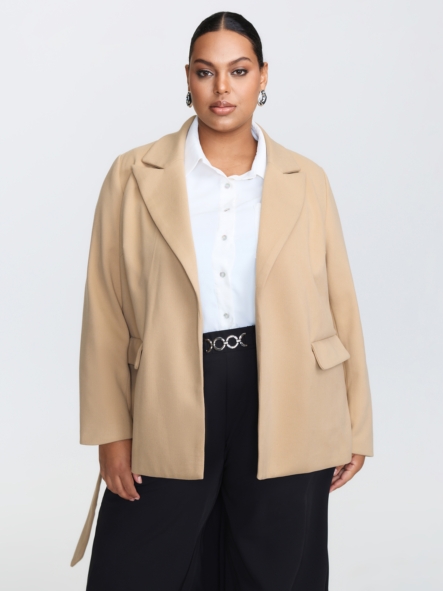 Side view of BloomChic Women's Plus Size Textured Belted Plain Blazer Tan not graphics Wide Waistband Sleeve Long Sleeve Notched Lapel 26/4X