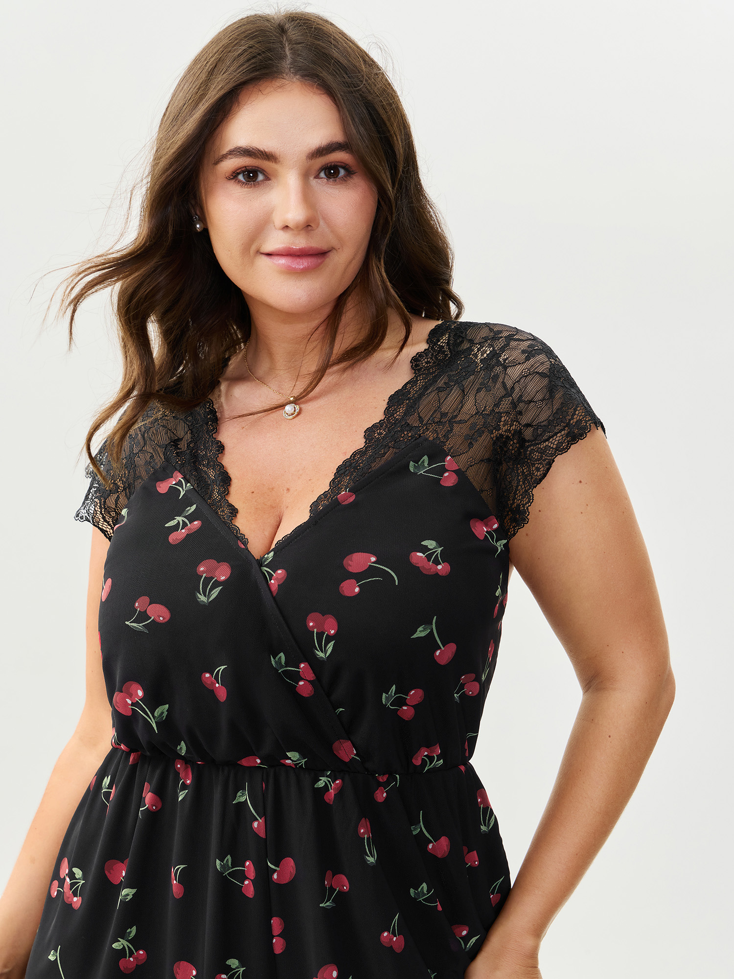 Side view of BloomChic Women's Plus Size Sweet Cherry Lace Sleeve Lounge Romper Black Fruit V-Neck Pajama Jumpsuits 14-16/1X