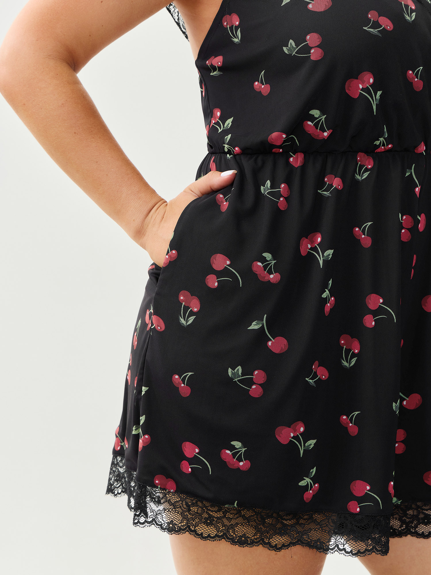 Side view of BloomChic Women's Plus Size Sweet Cherry Lace Sleeve Lounge Romper Black Fruit V-Neck Pajama Jumpsuits 14-16/1X