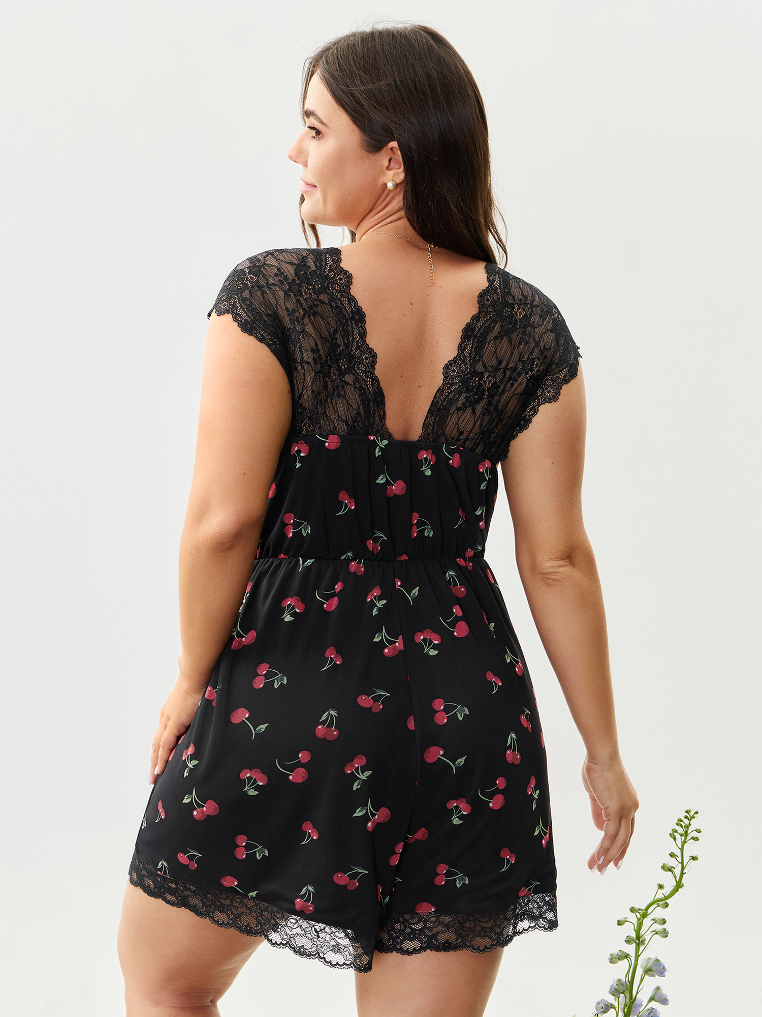 Side view of BloomChic Women's Plus Size Sweet Cherry Lace Sleeve Lounge Romper Black Fruit V-Neck Pajama Jumpsuits 14-16/1X