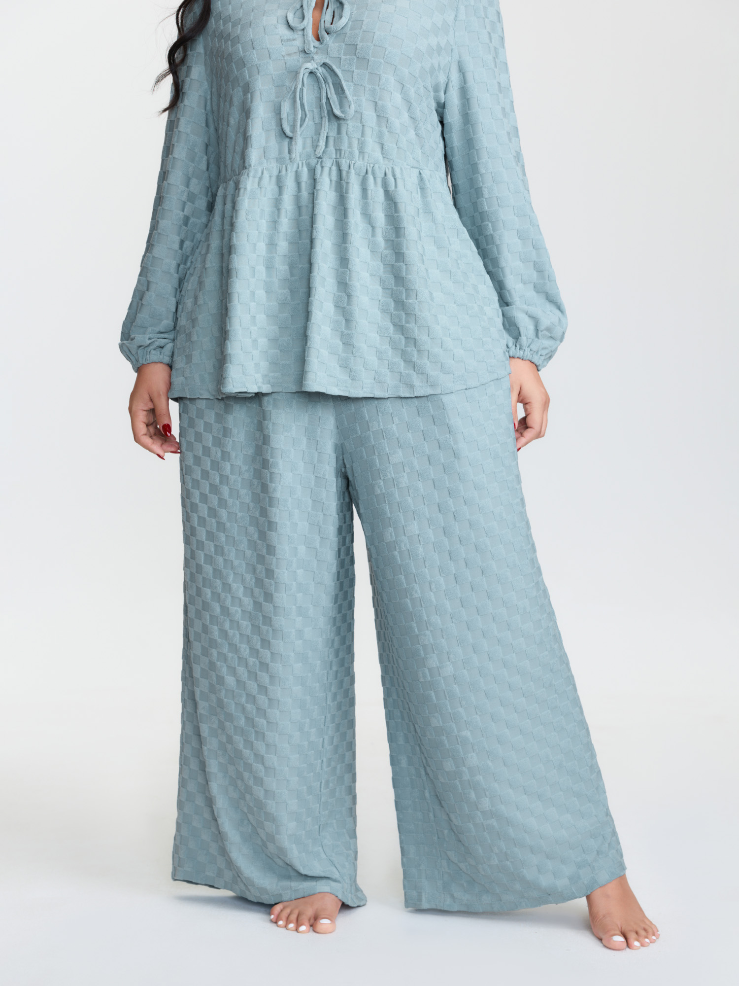 Side view of BloomChic Women's Plus Size Checkered Textured Co-ord Lounge Set LightBlue Solid Long Sleeve Smocked 22-24/3X